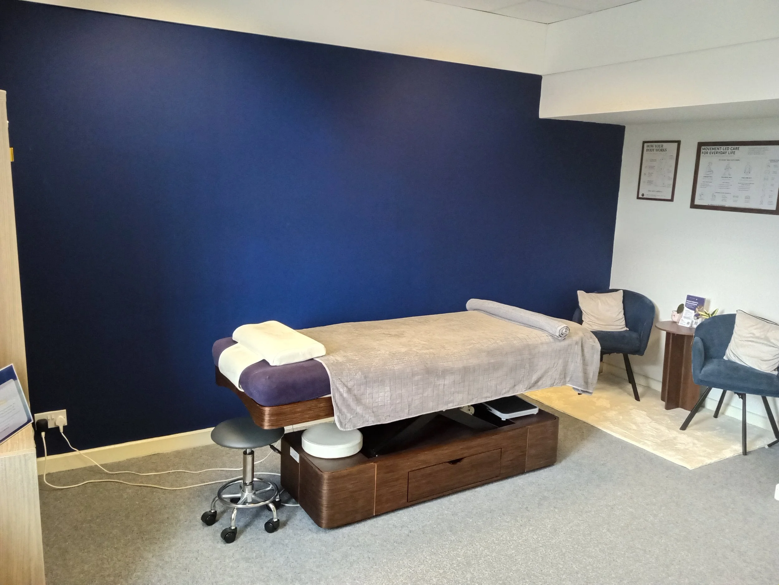 wide shot of RCMM clinic in East Kilbride showing massage bed and seating area