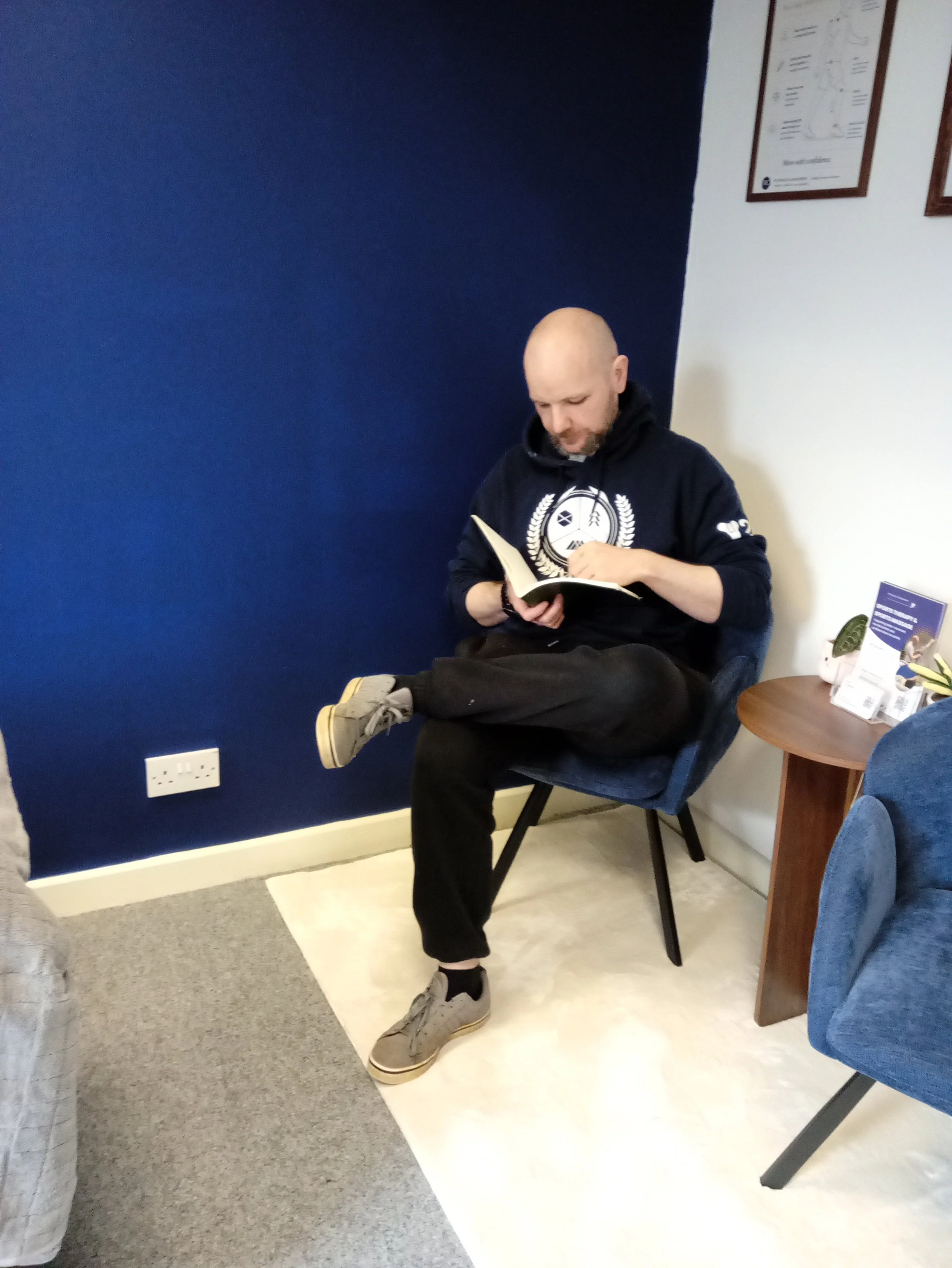 ross sports therapist taking client notes in RCMM clinic