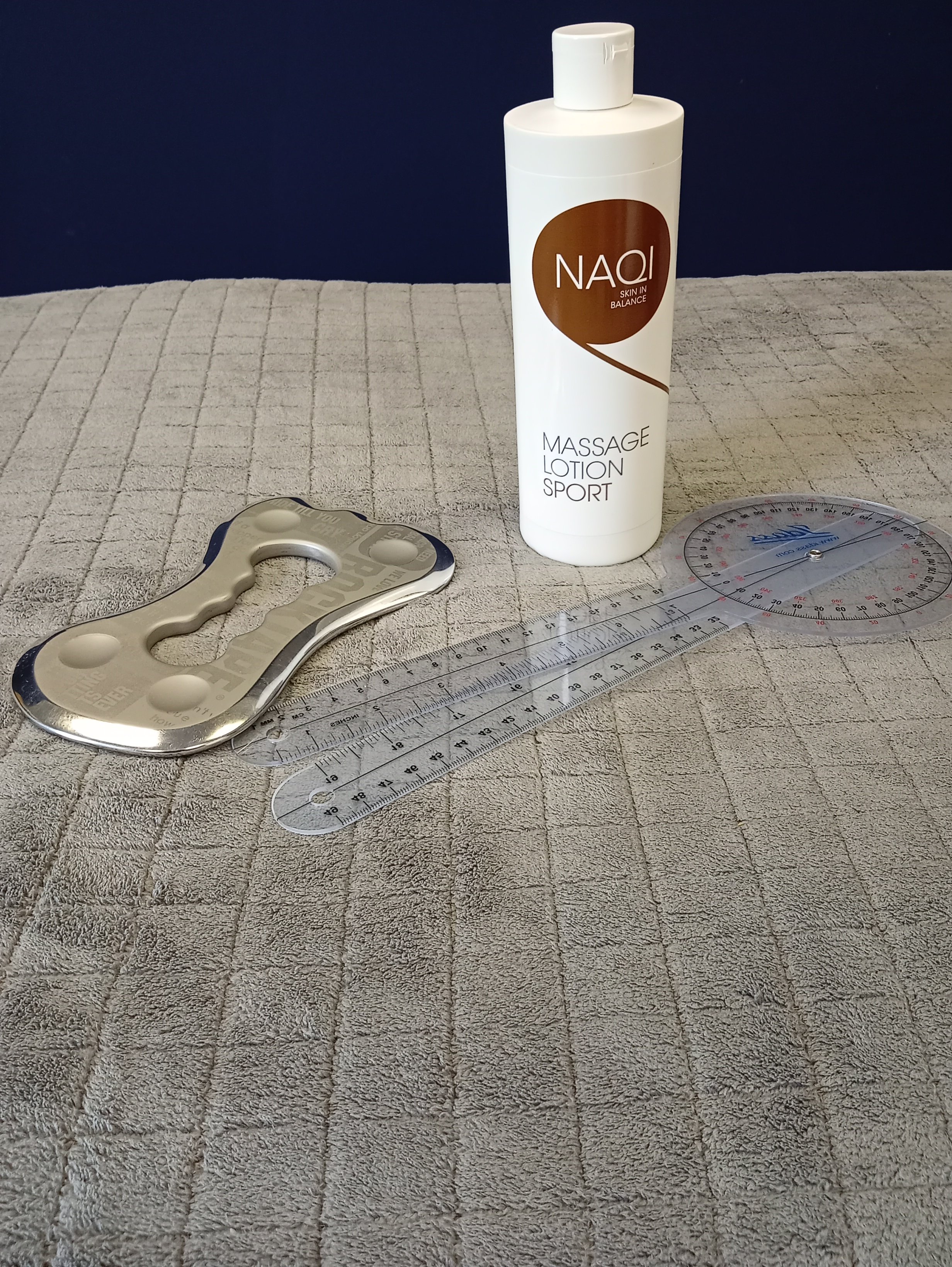 picture of massage oil , massage scraping tool and ruler for bio-mechanics assessment