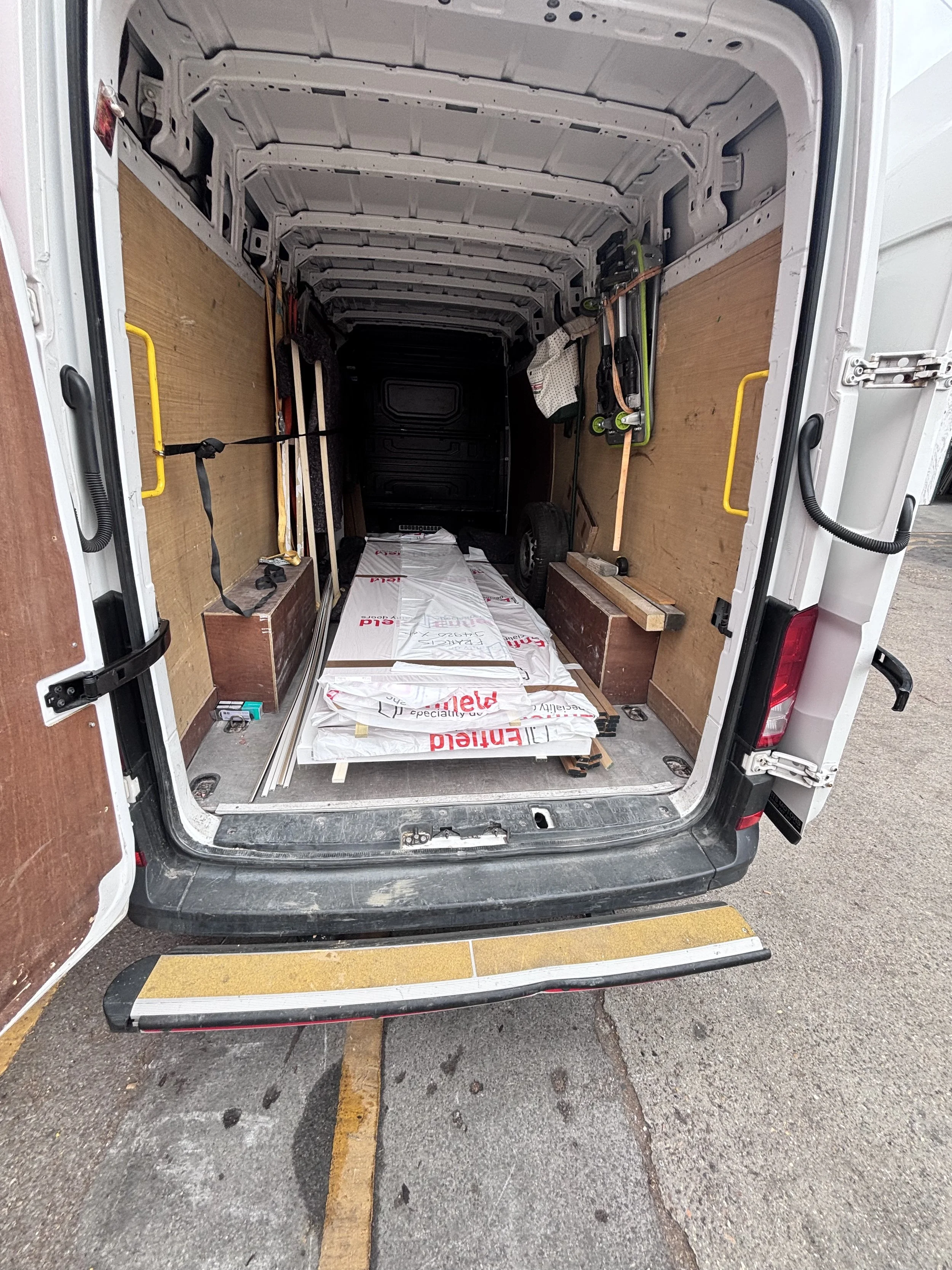 Long timber and building materials loaded inside an XLWB courier van