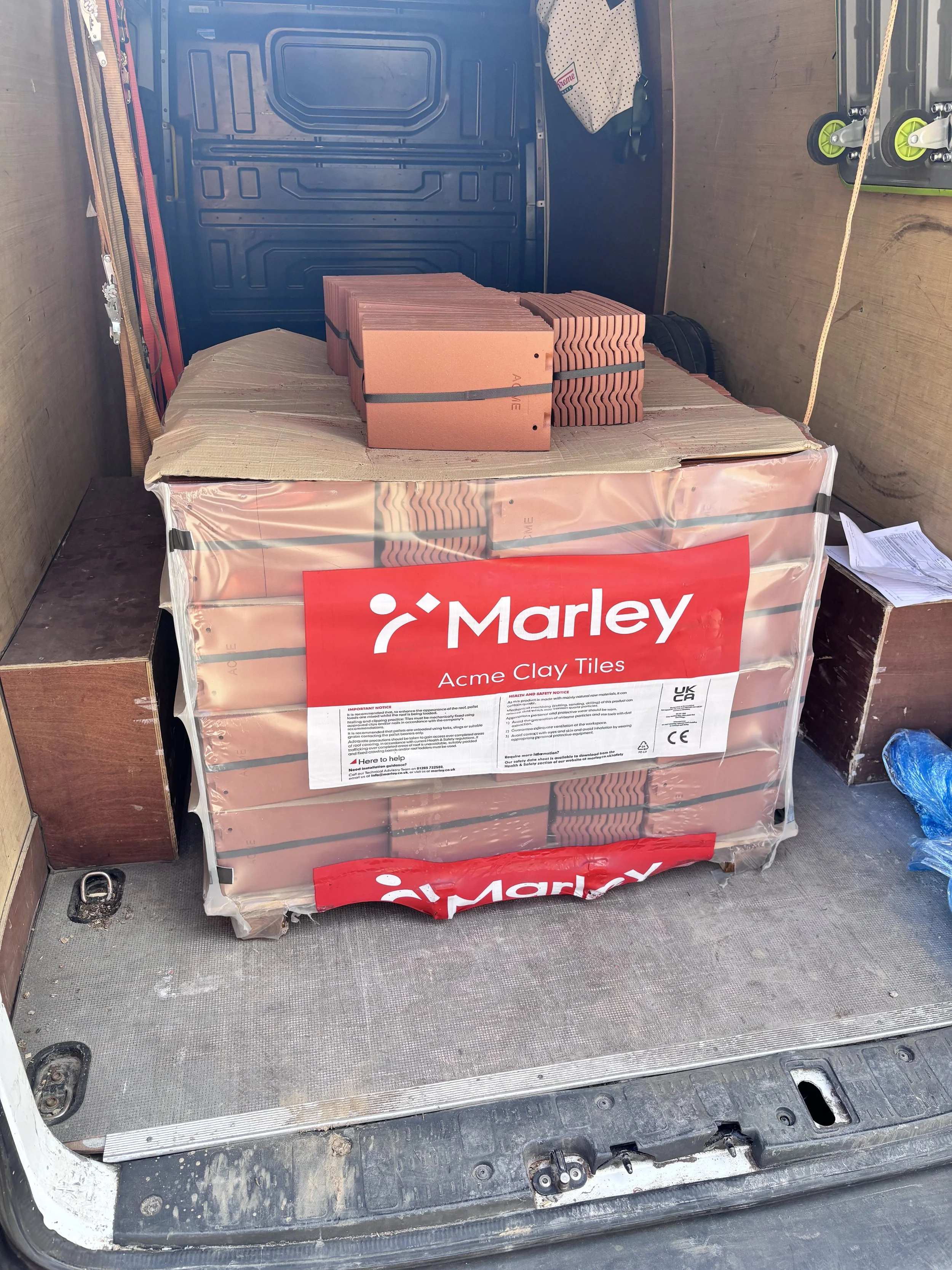 Marley roofing tiles loaded inside a dedicated builders merchant delivery van