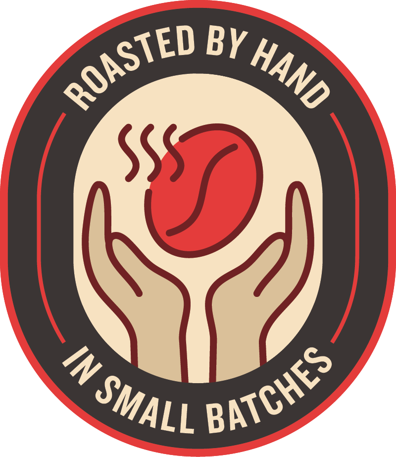 A label with a circular design featuring two hands holding a steaming coffee bean or similar object, with the text "Roasted by Hand in Small Batches" around the image.