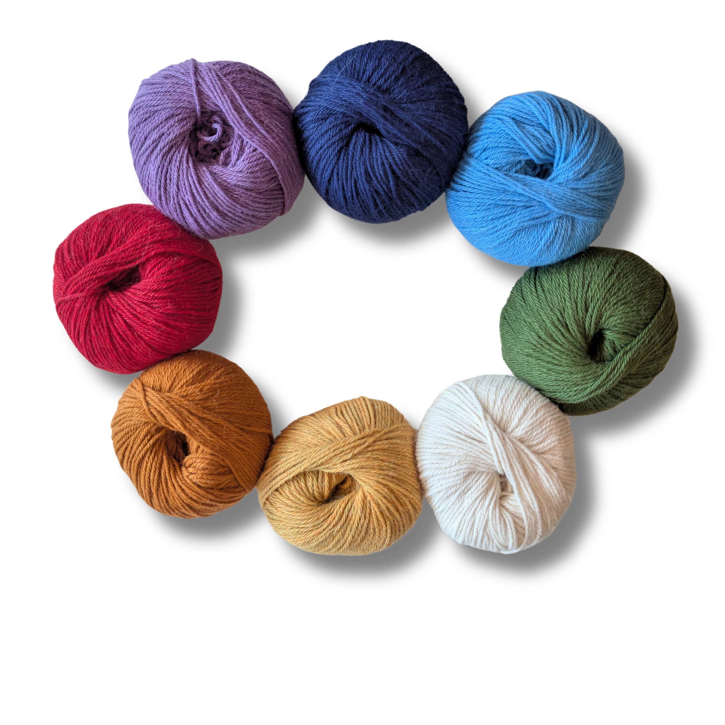 Bunte Wollknäuel aus 100% Babyalpaka Wolle in Rot, Rosa, Blau, Grün, Braun, Weiß, Gelb, Violett, und Hellblau.