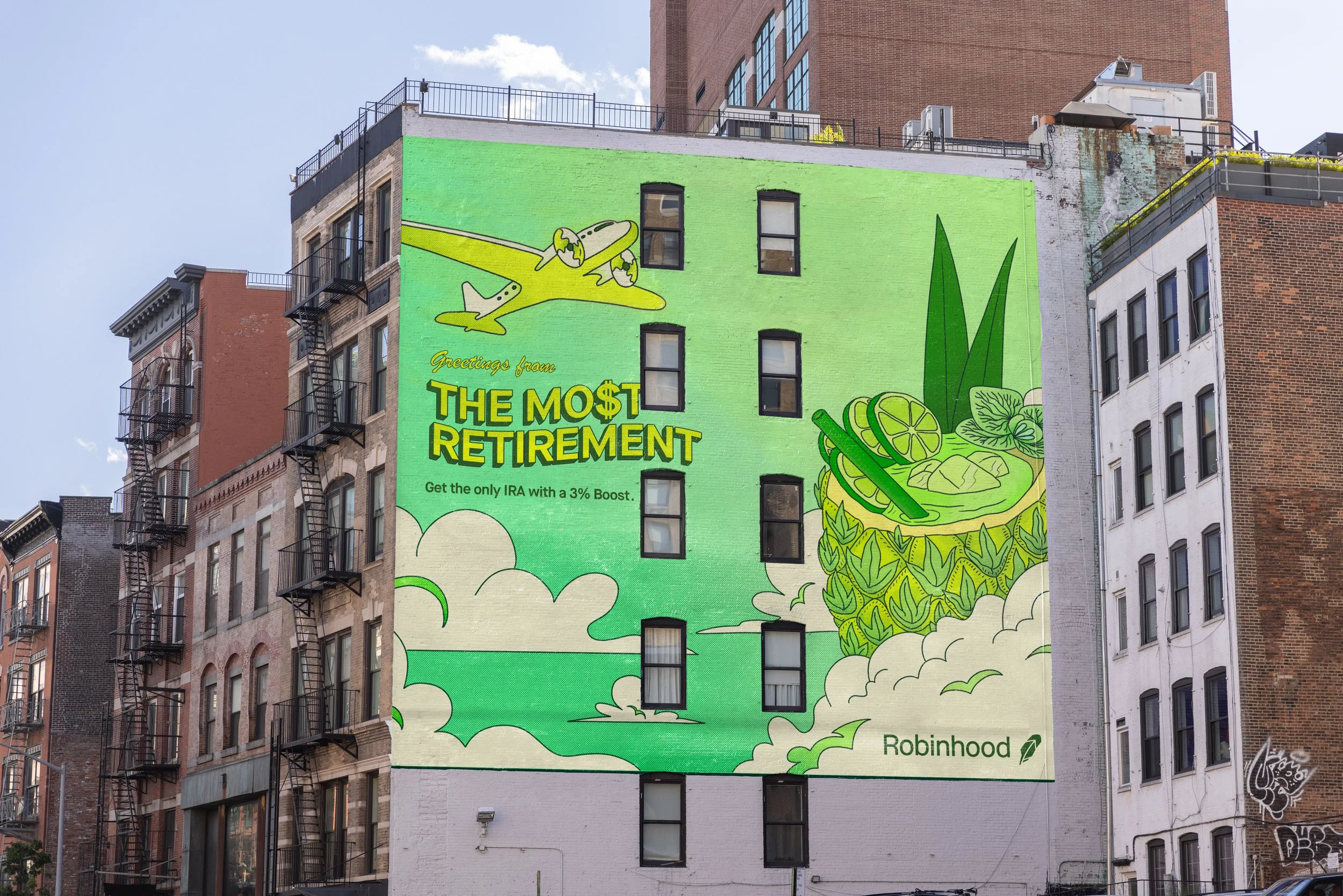 A large green mural on the side of a multi-story building depicting a cartoon airplane flying over clouds, with a large kombucha drink with lemon slices and leaves on the right. The text reads, "Greetings from THE MOST RETIREMENT" and "Get the only IRA with a 3% Boost." The mural promotes Robinhood.