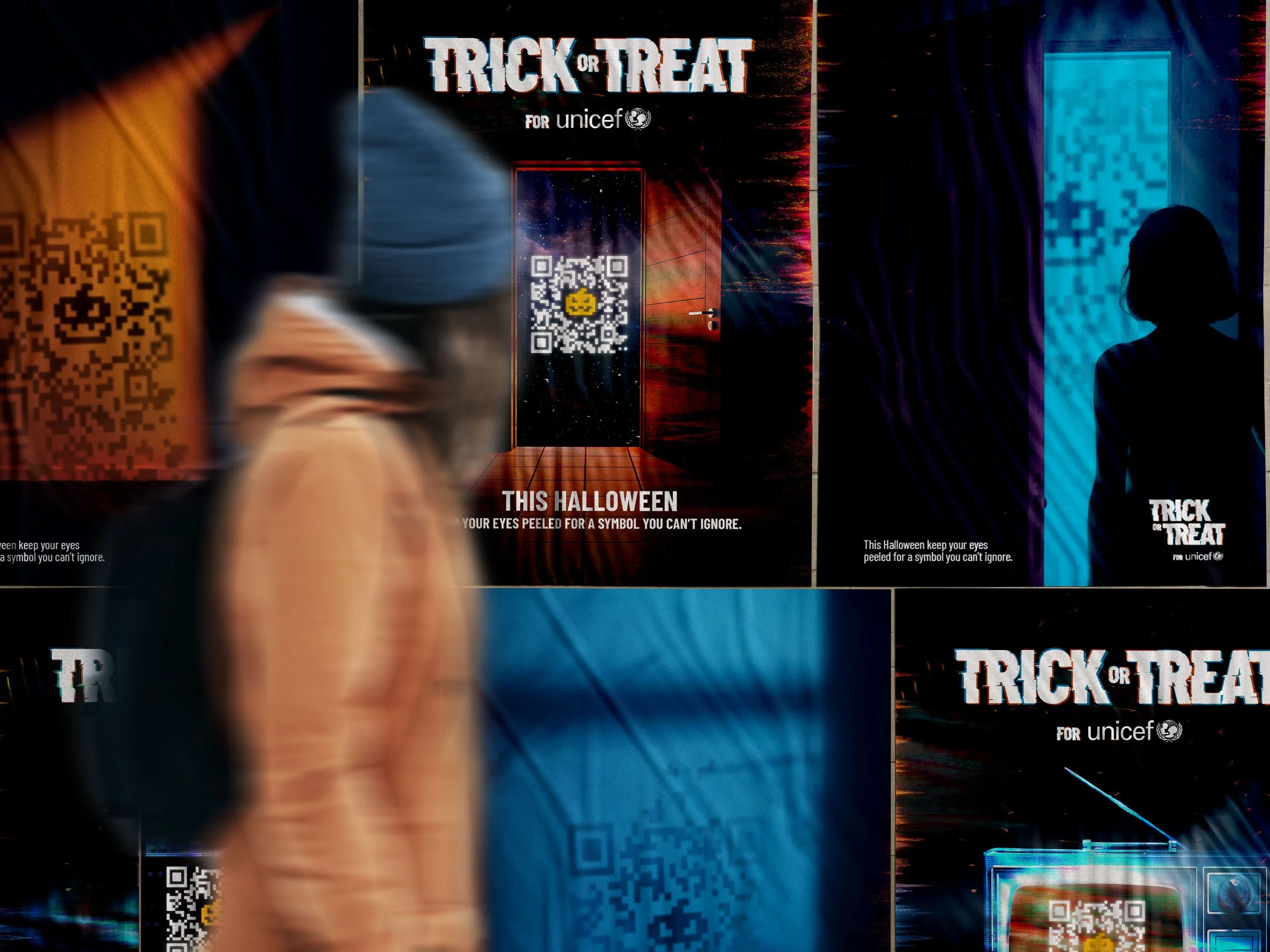 Blurred person walking past Halloween-themed posters with QR codes on a wall promoting Trick or Treat for UNICEF, featuring spooky designs and symbols.