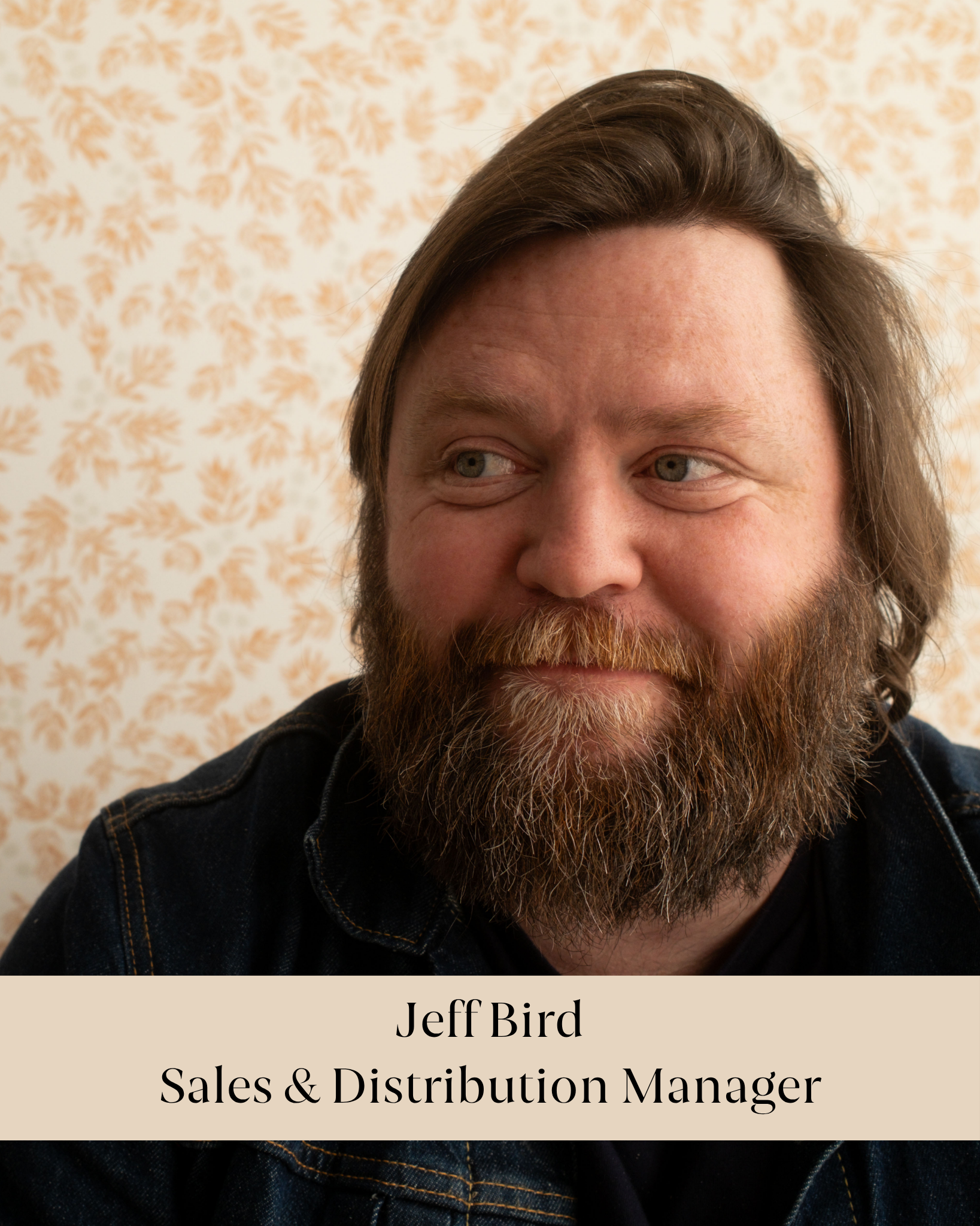 Close-up photo of a man with long brown hair, light skin, and a beard, wearing a black jacket, with a patterned background. The overlay text reads: "Jeff Bird Sales & Distribution Manager."