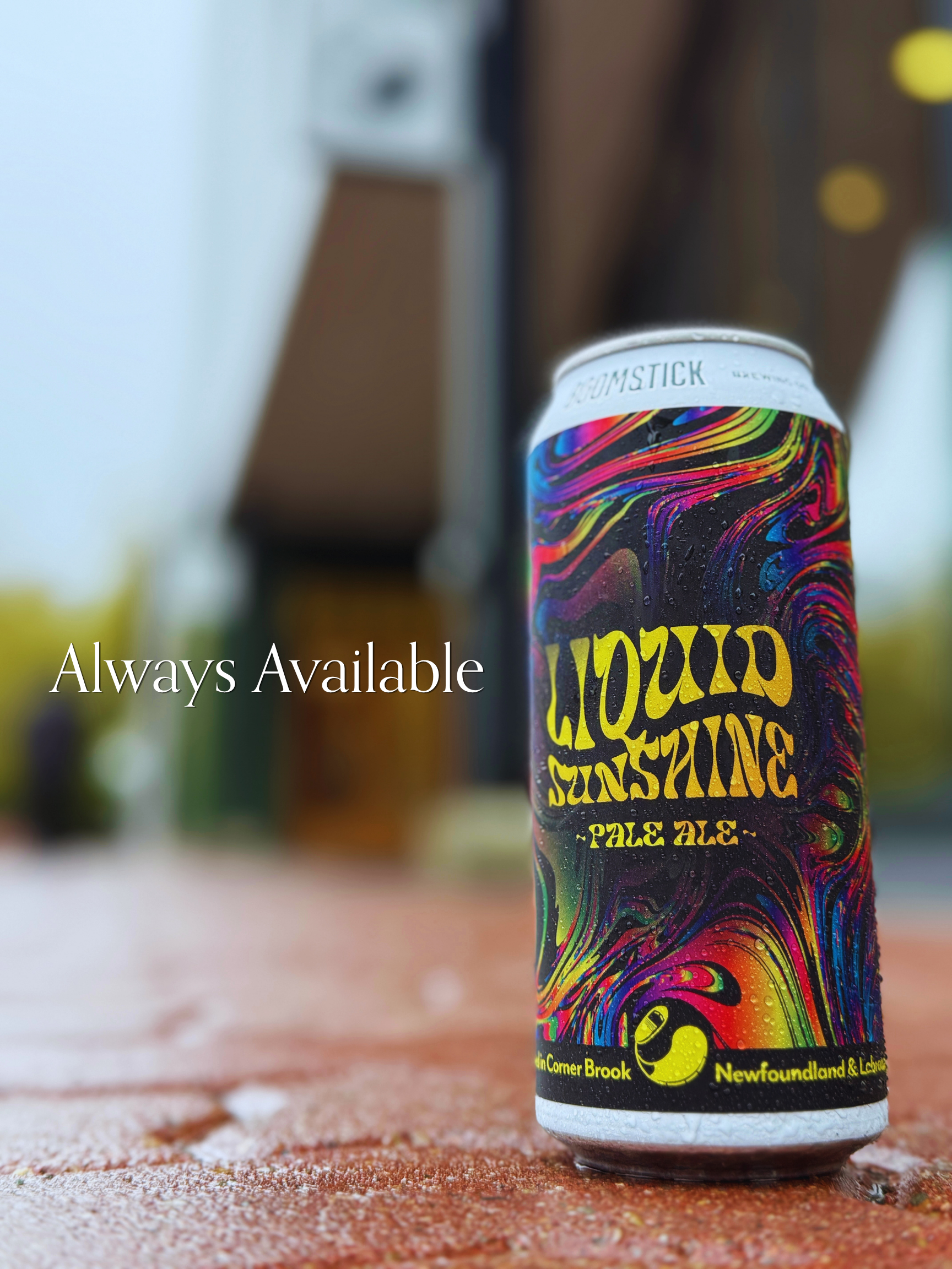 A colorful can of Guinness beer on a textured surface with a blurred background.
