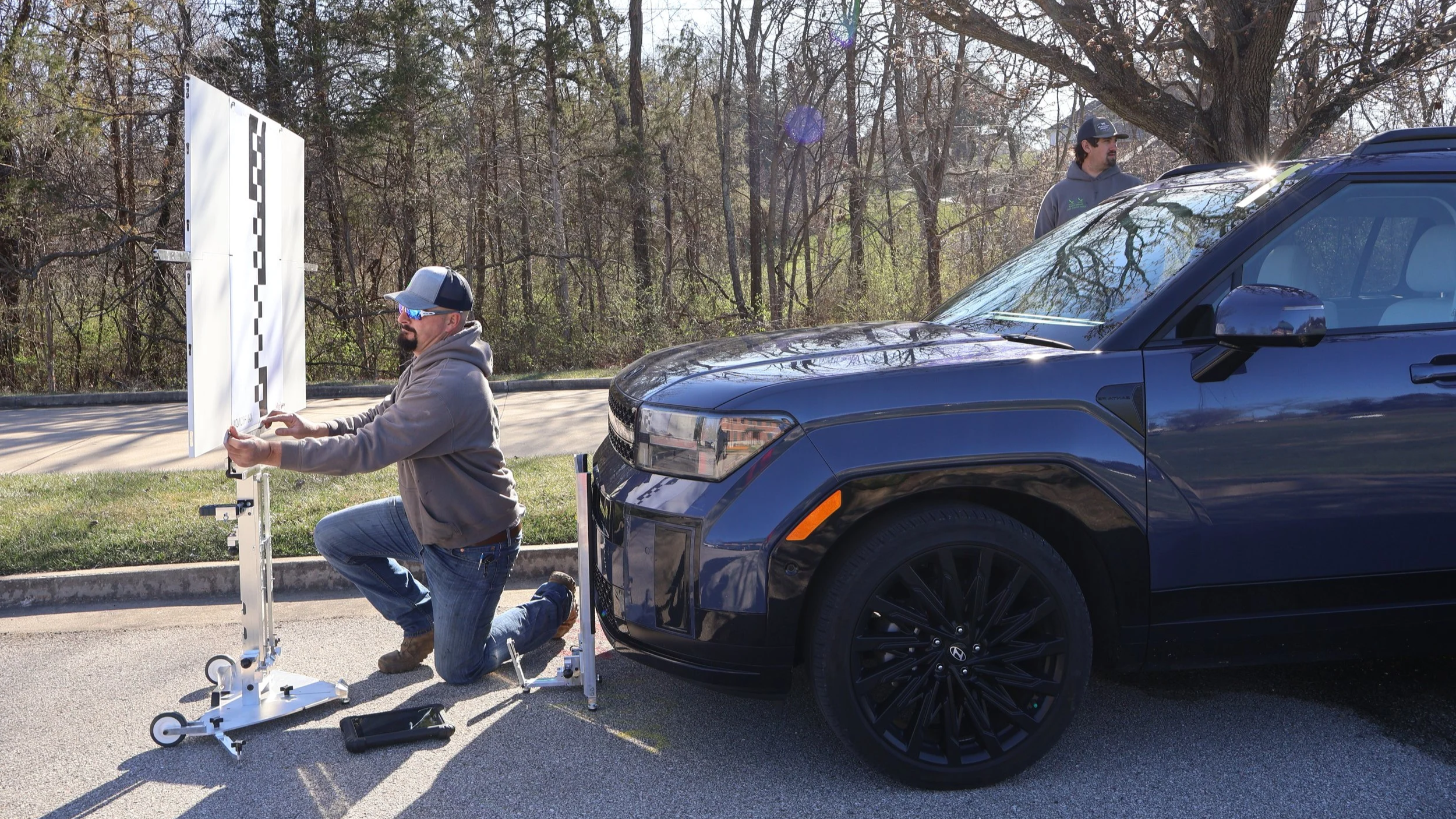 Glass repair tech recalibrating vehicle after new window installation