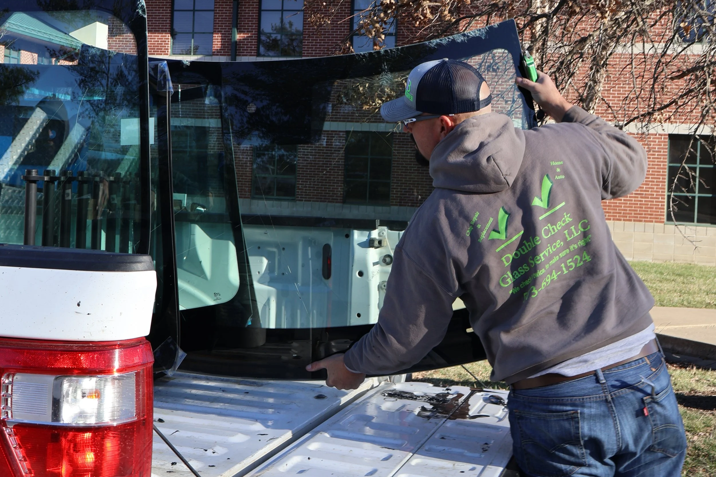 Image of glass repair technician loading broken windshield