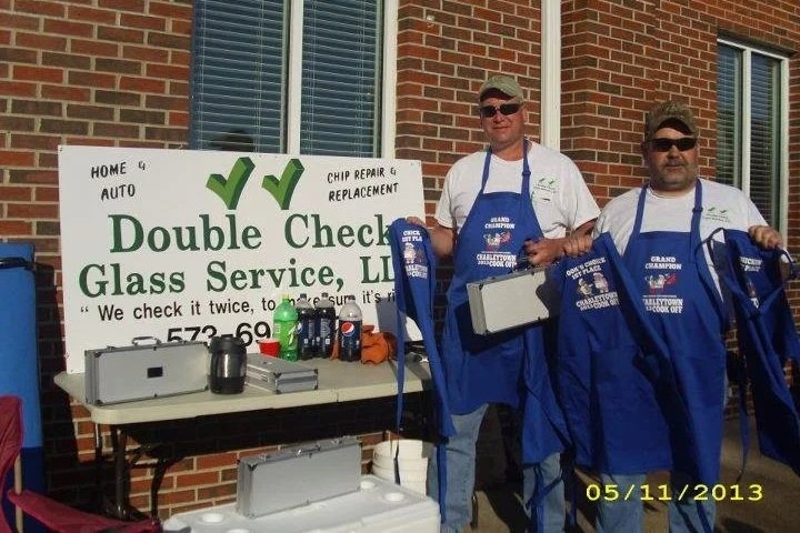 Image of cook off winners standing in front of a Double Check Glass Service sign