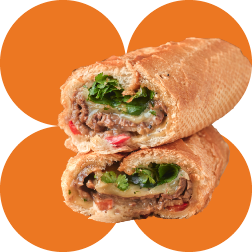 Close-up of Banh Mi Boy sandwich showing green cilantro, red pepper, and beef filling on an orange background.