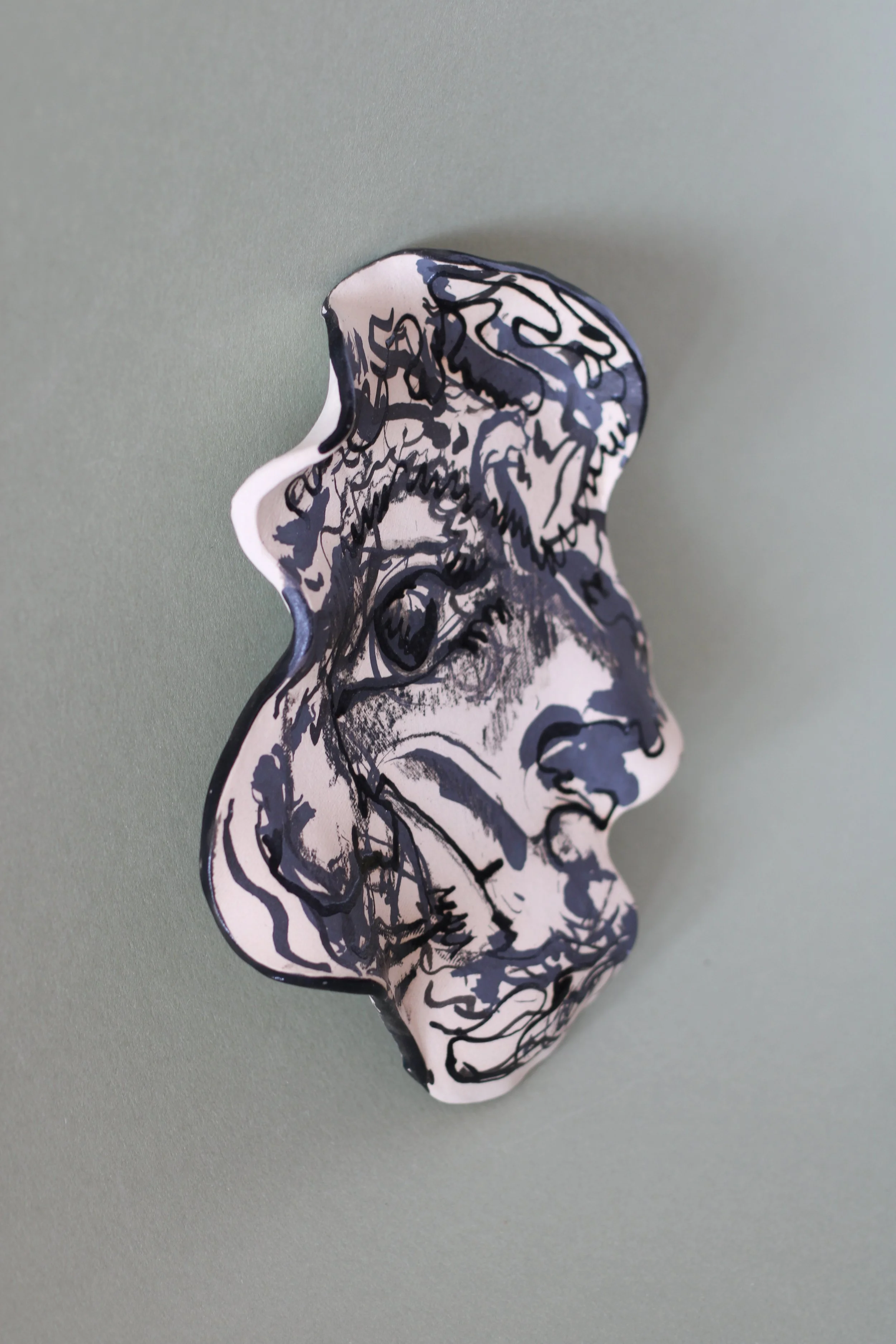 Side view of a hand-built ceramic plate showing its handcrafted ceramic surface and form.