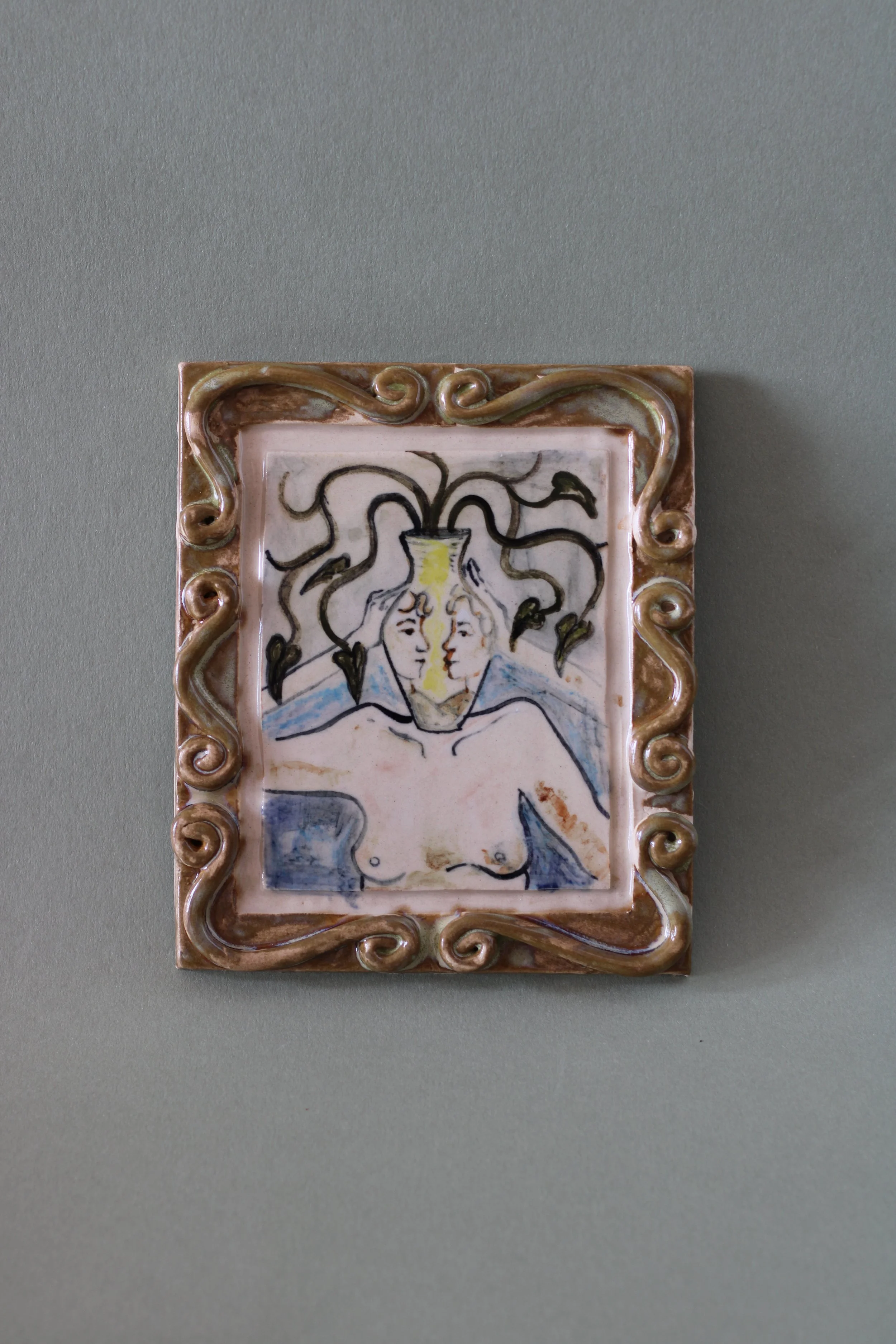Hand-built ceramic wall piece featuring illustrated botanical forms, flowing linework and layered ceramic glazes.