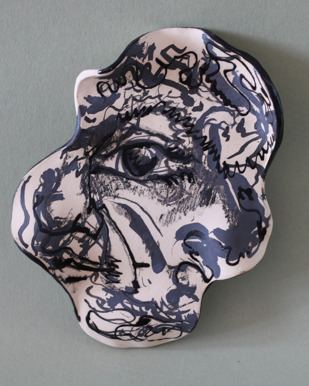 Hand-built illustrated ceramic plate featuring an eye motif with flowing linework, marbled glazes and handcrafted surface textures.
