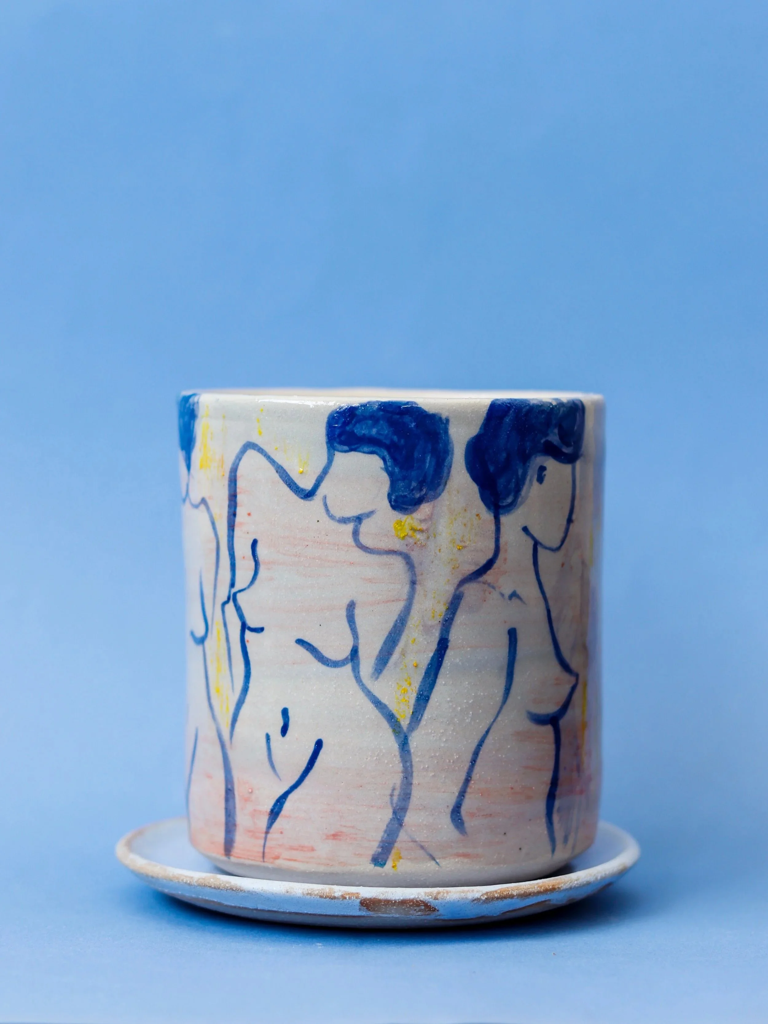 Hand-built ceramic vessel featuring original hand-drawn figures illustrated with custom ceramic glazes, combining sculpture, drawing and functional design.