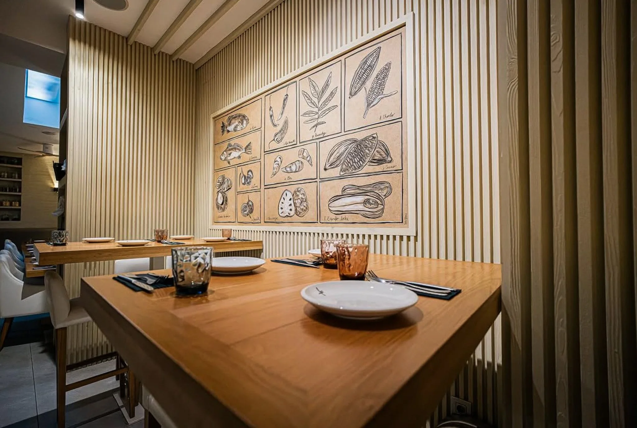 Large-scale illustrated wall installation for Leche de Tigre restaurant in Barcelona, depicting hand-drawn peruvian culinary ingredients and botanical forms.