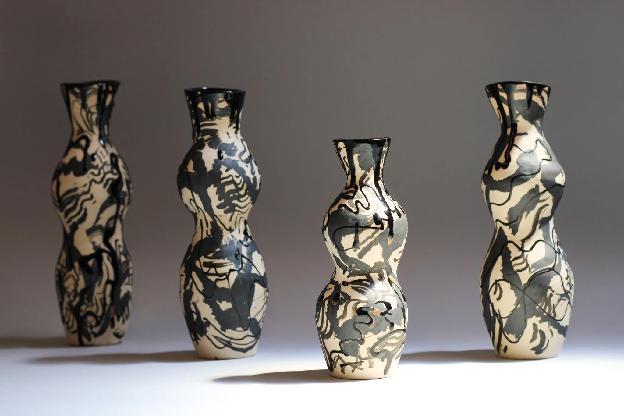 Five sculptural Marbled Dream ceramic candleholder inspired by the female figure, featuring layered glazes and organic flowing forms, photographed for Instagram.