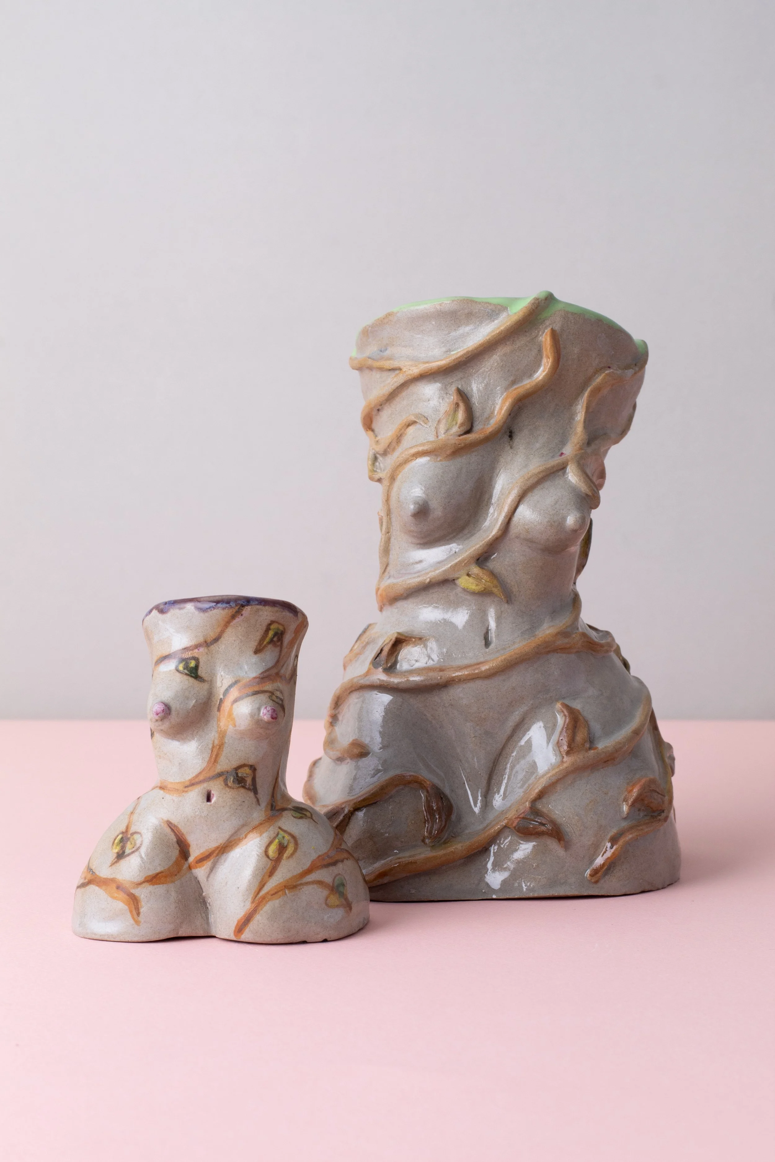 Ceramic candleholder inspired by the female figure, featuring sculped botanical illustrations, flowing vines and layered ceramic glazes.