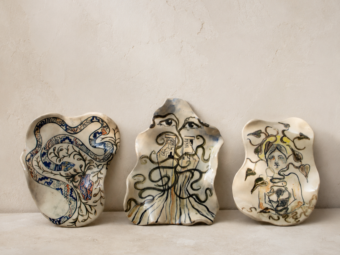 Collection of hand-built illustrated ceramic wall plates featuring original hand-drawn compositions inspired by the Amazonian myth of the Yacumama, finished with custom ceramic glazes.