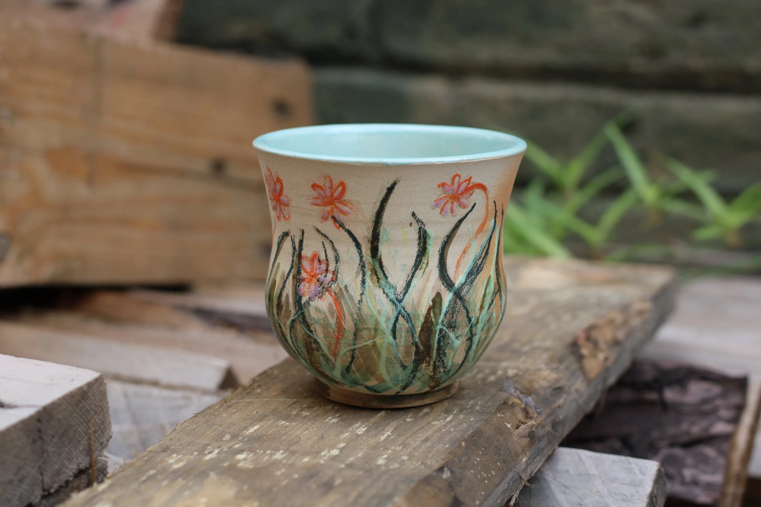 Hand-built ceramic cup with hand-painted botanical illustrations, commissioned by a private collector and inspired by the whimsical atmosphere of a fairy garden.