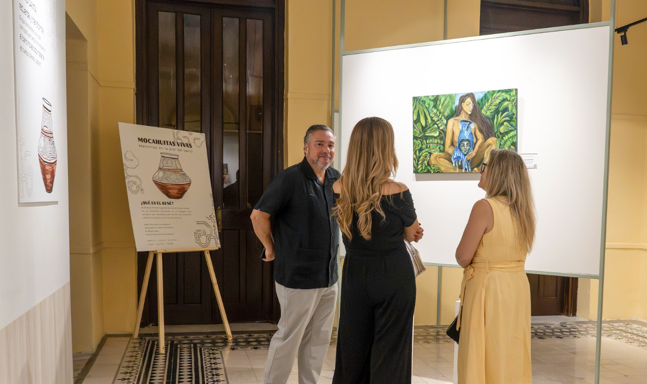 Visitors viewing Valeria R.O.'s artwork during the Memorias del Barro exhibition in Panama.
