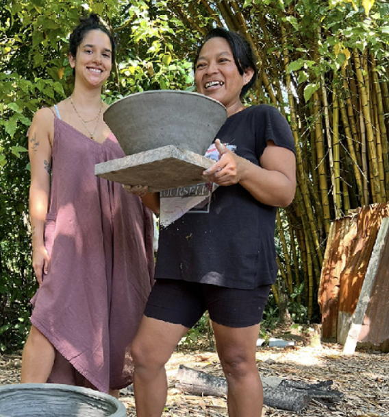 Portrait of Valeria R.O. alongside a ceramic artisan holding a traditional handcrafted vessel in the Peruvian Amazon.