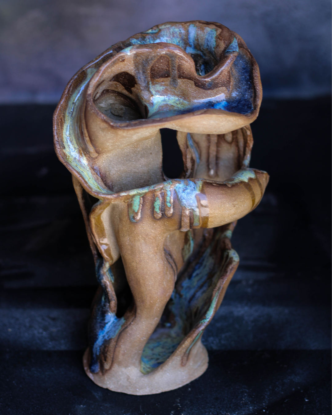 Hand-built ceramic vessel with fluid sculptural curves, layered openings and a hand-finished ceramic surface inspired by the movement of flowing water, and personally formulated glazes.