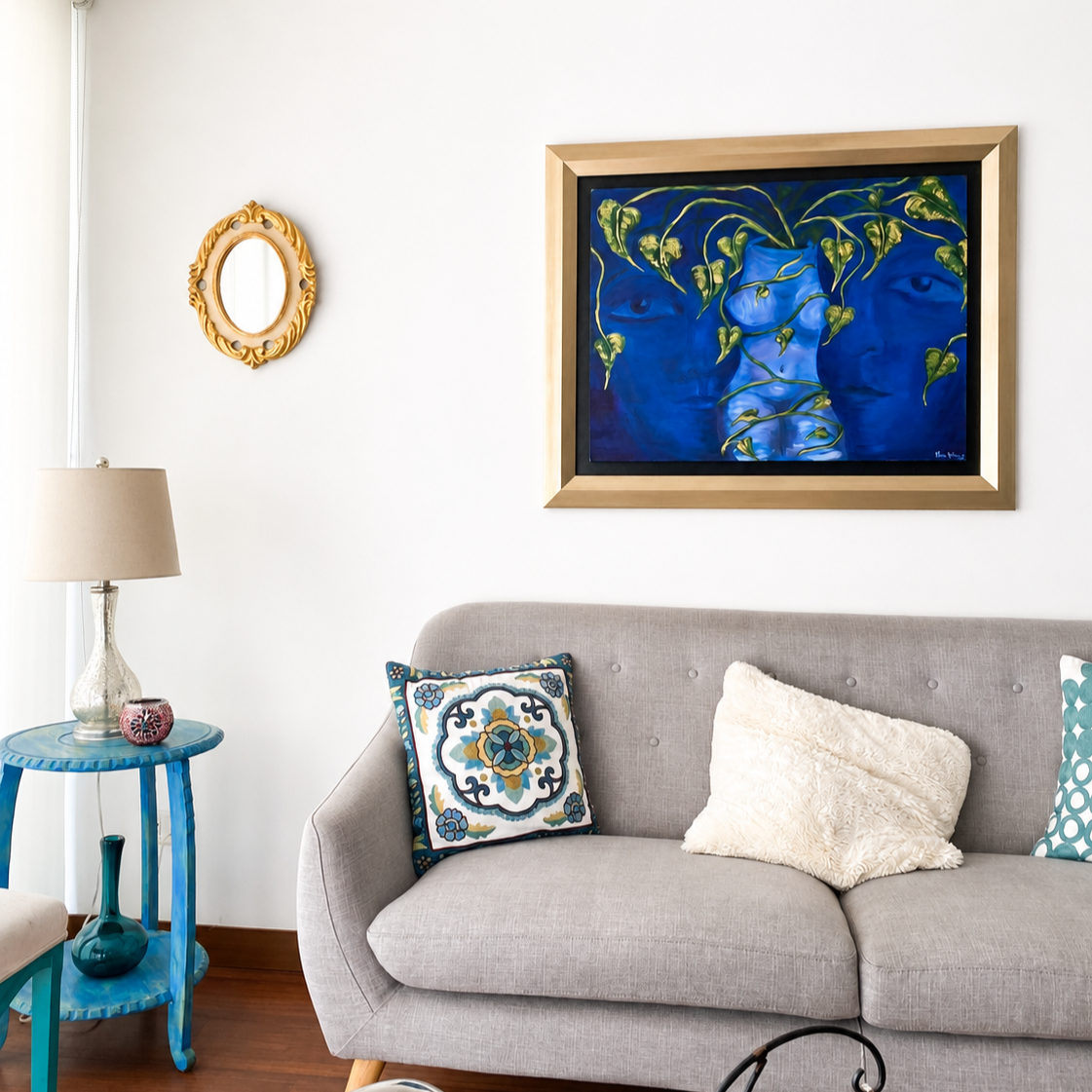 Oil painting featuring two blue faces surrounding a softly emerging central figure, with winding green vines forming a layered organic composition, displayed in the living space of a private collector.