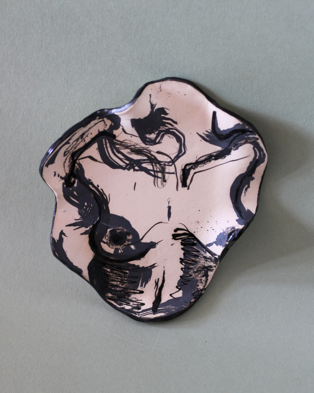Hand-built illustrated ceramic plate featuring an abstract body motif with flowing linework, marbled glazes and handcrafted ceramic surfaces.