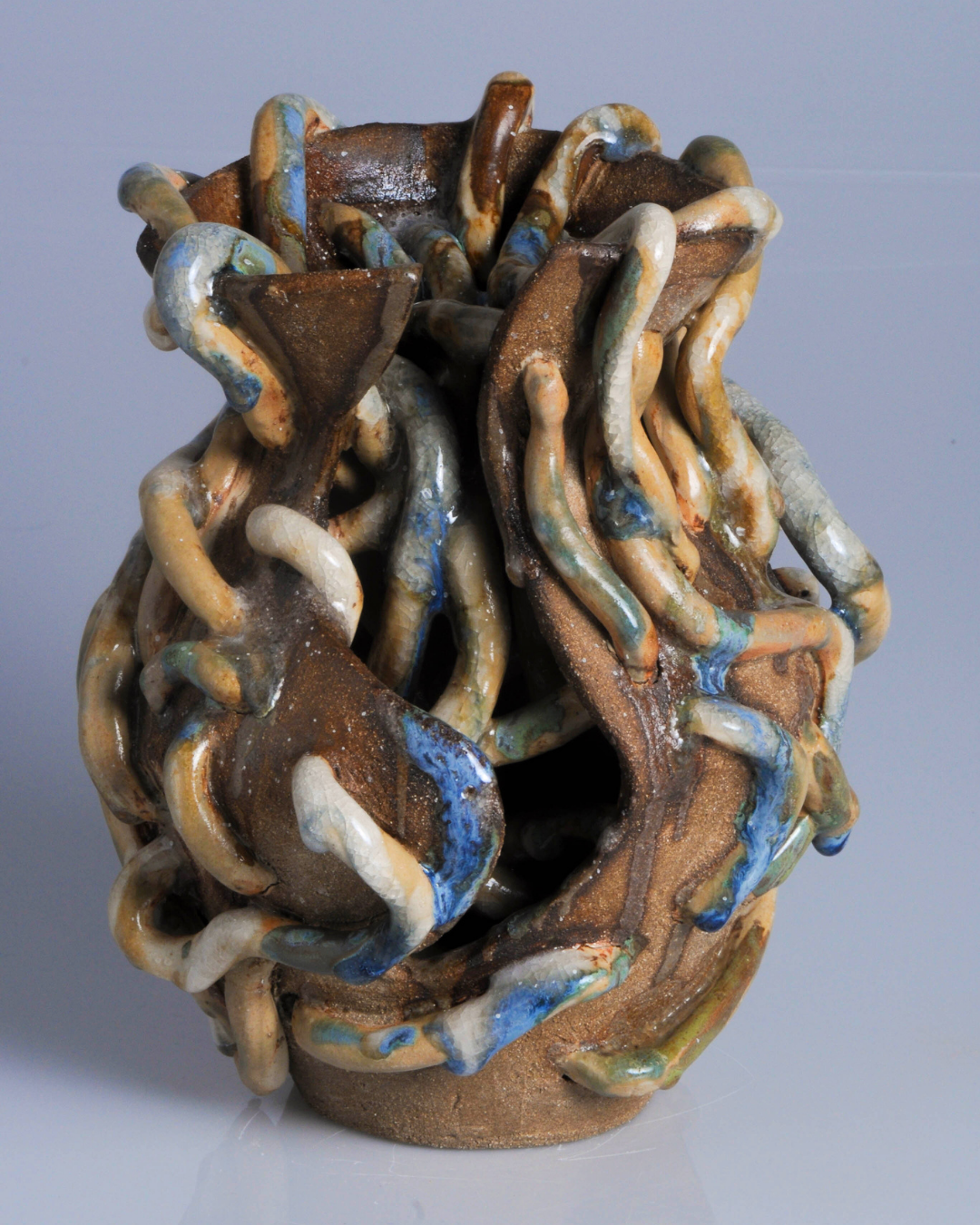 Hand-built ceramic sculpture with flowing forms and sculptural openings inspired by the looping waterways of Amazonian tipishkas.