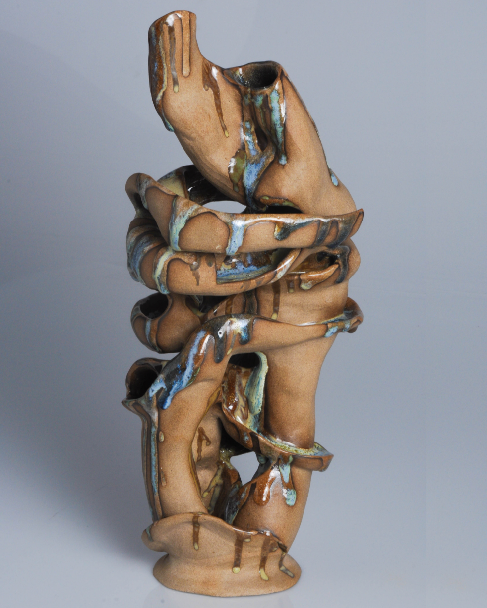 Hand-built ceramic sculpture composed of two interconnected organic forms, featuring hand-built textures and flowing sculptural curves.