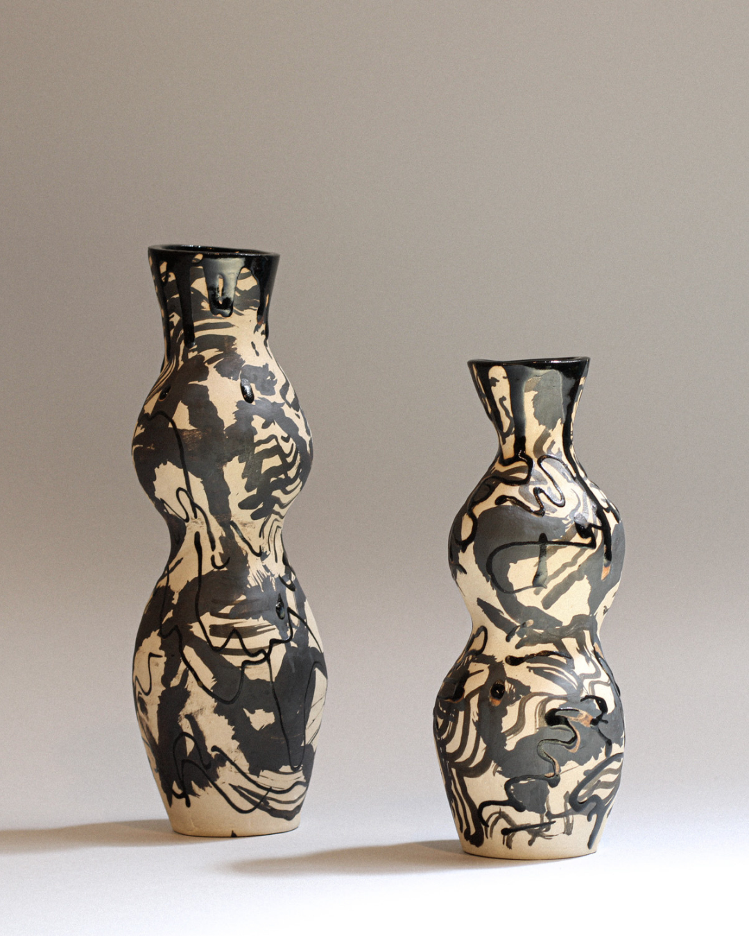 Ceramic candleholder featuring flowing organic forms, marbled ceramic glazes and illustrated linework.