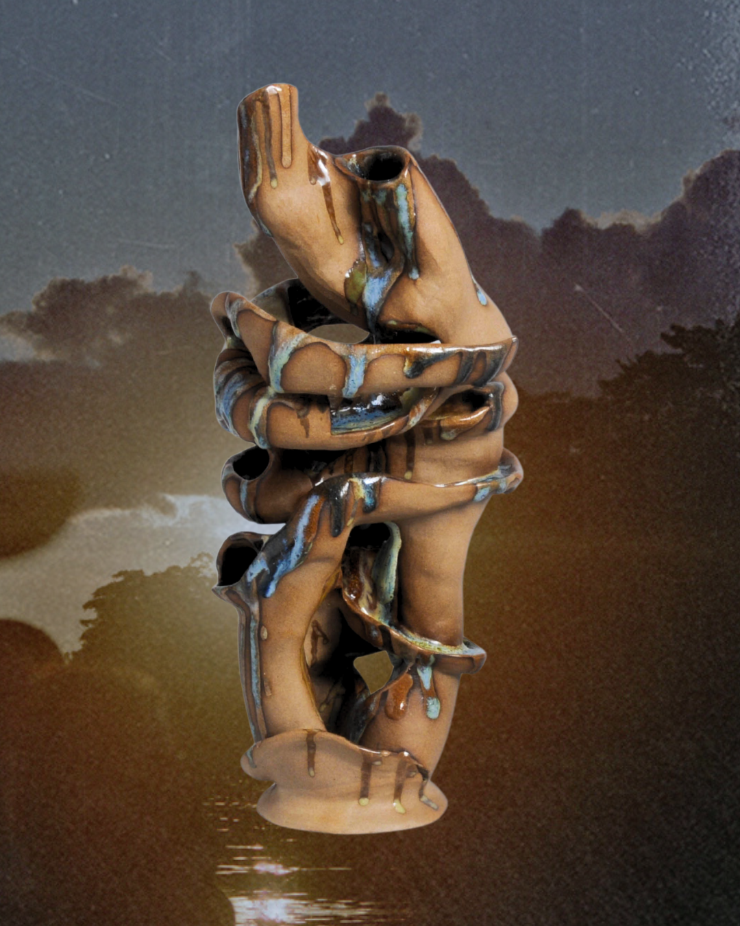 Hand-built ceramic sculpture from the Atravesar series, featuring two intertwined organic forms and personally formulated ceramic glazes