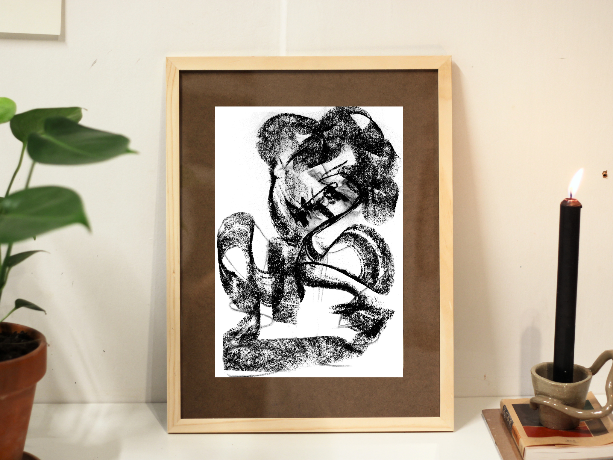 Framed charcoal drawing Melting Mindscape displayed in a living room, featuring expressive organic forms and layered textures.