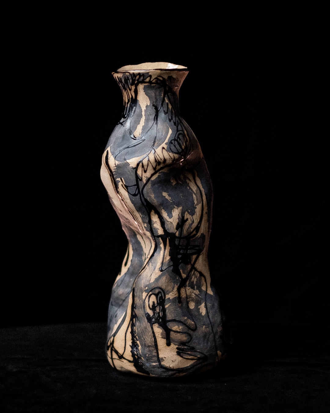 Ceramic vessel with an organic sculptural form, featuring illustrated linework and marbled ceramic glazes.
