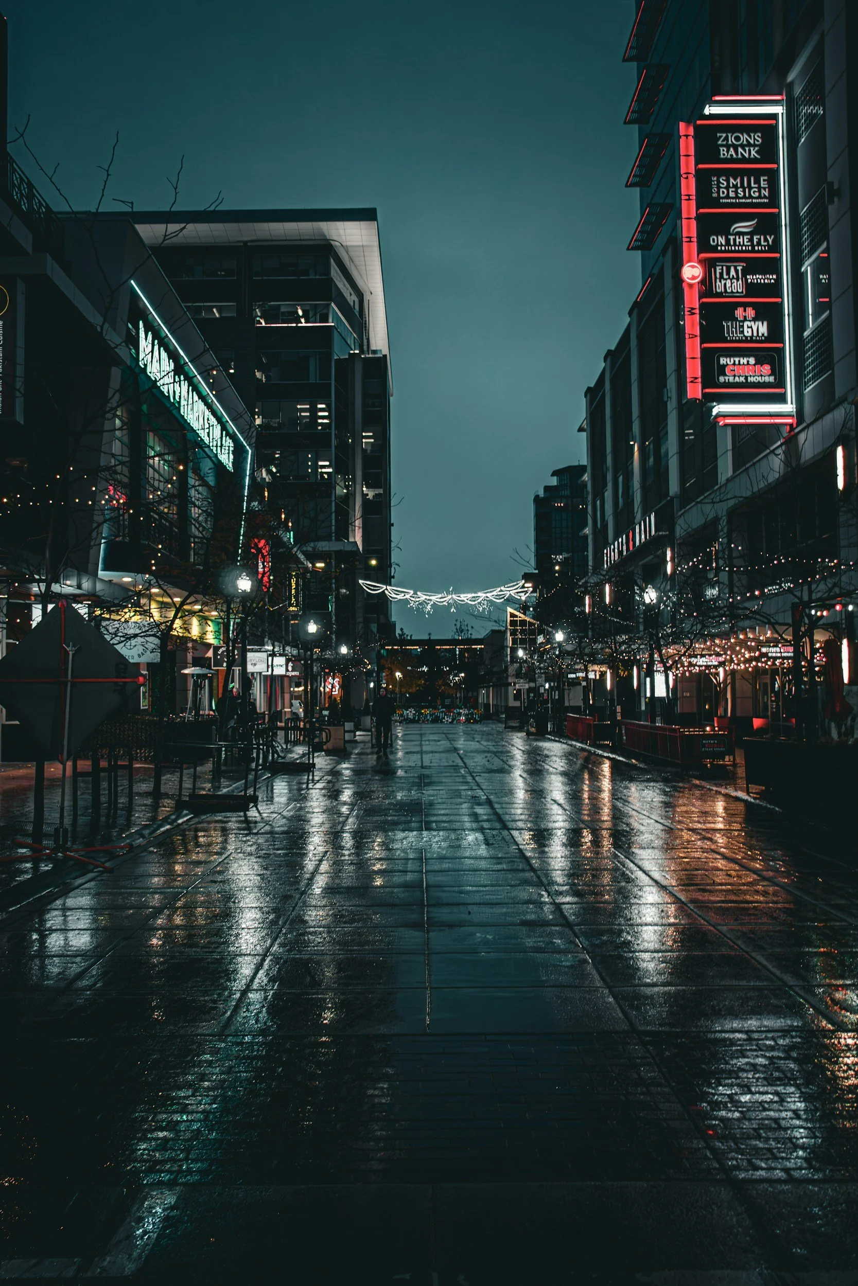 wet sidewalk boise streets downtown night lowlight neon signs
