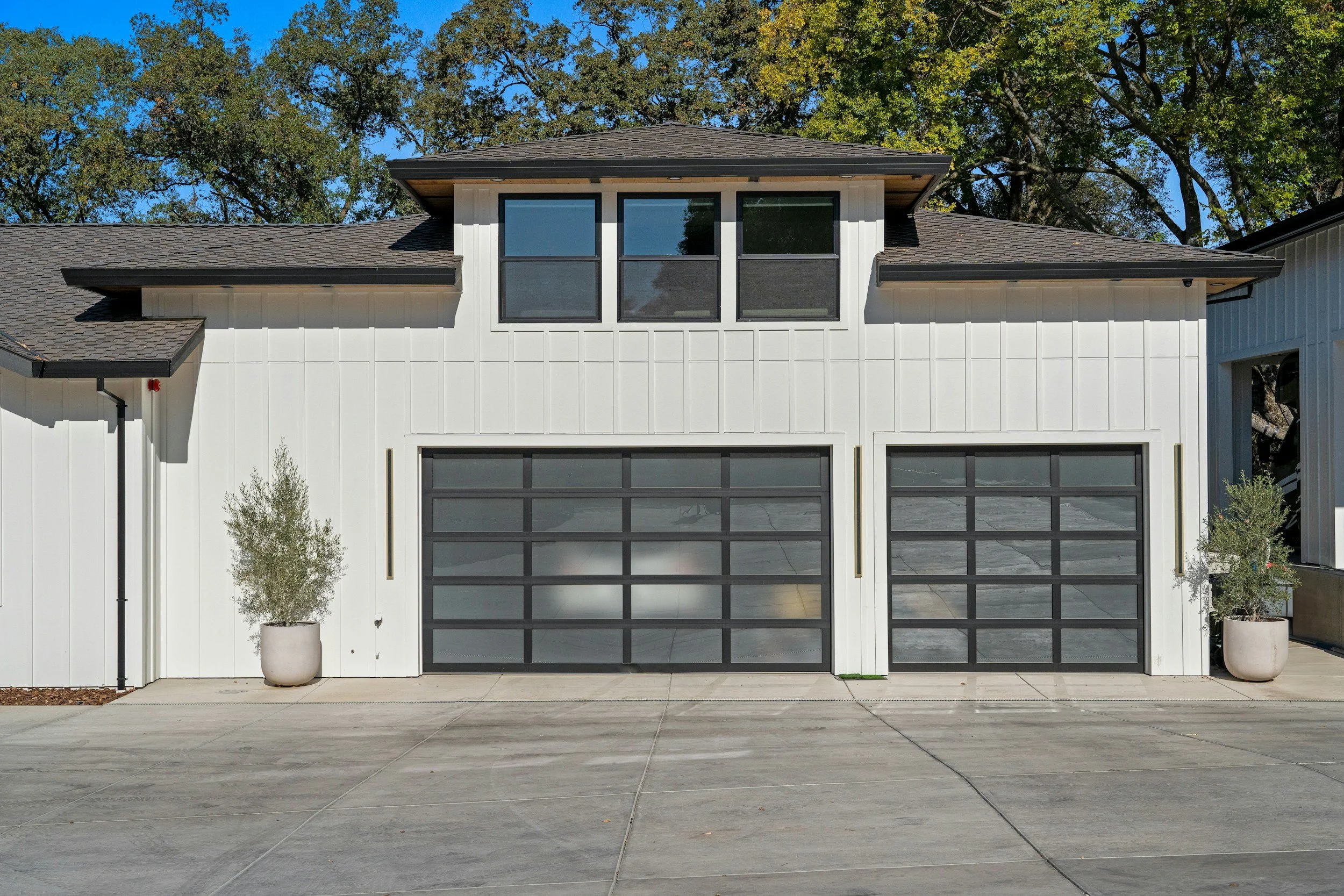 beautiful white paneled home with 3 car garage and freshly cleaned driveway