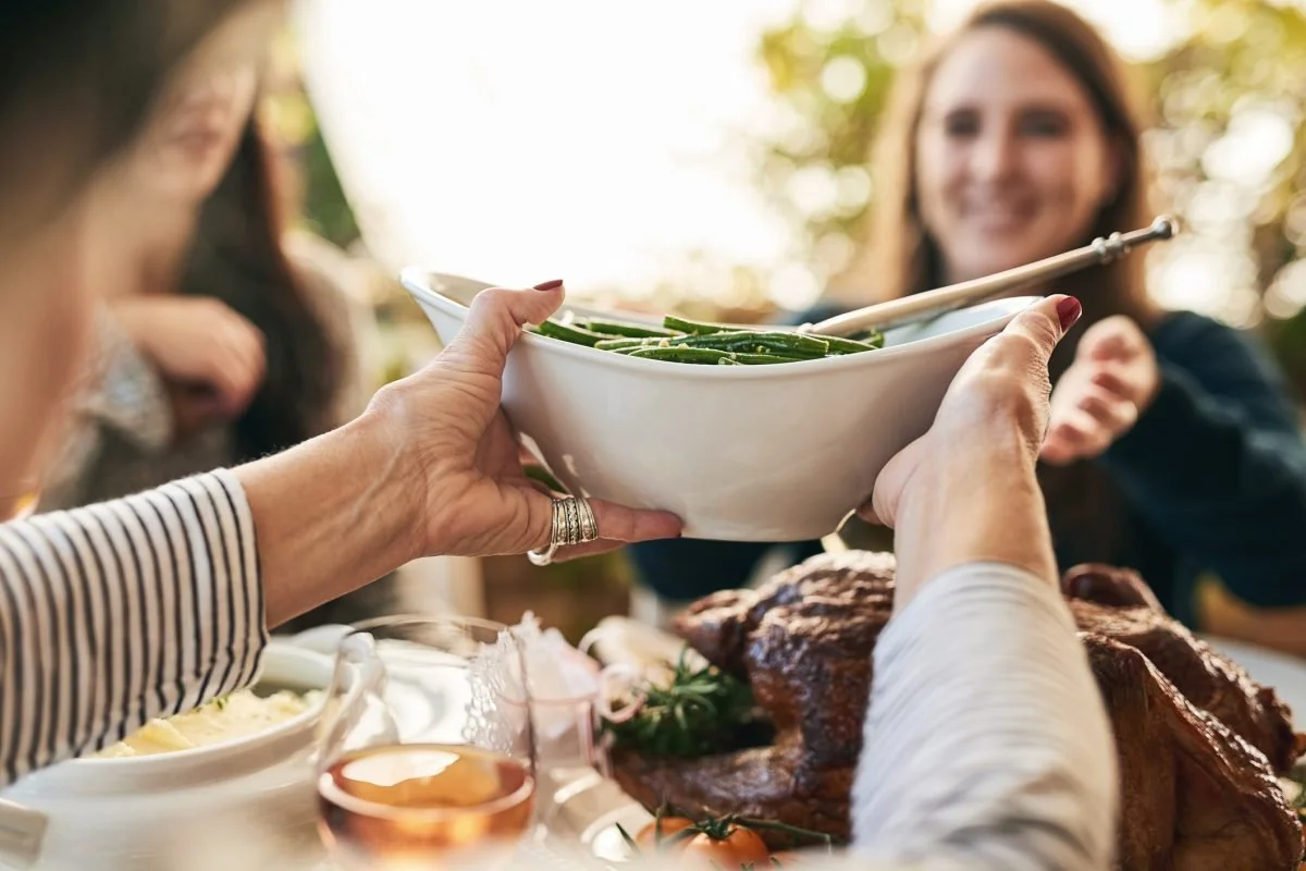 People able to happily share a meal outdoors after being safely supported to transition off GLP-1 medications and maintain weight loss