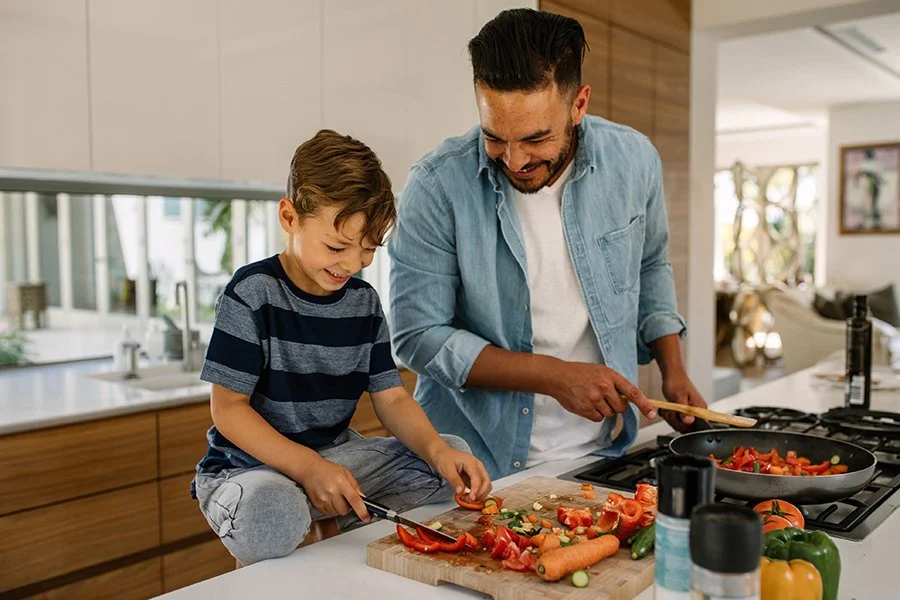 Man concerned about weight gain after stopping Wegovy practices meal planning and cooking with his family.