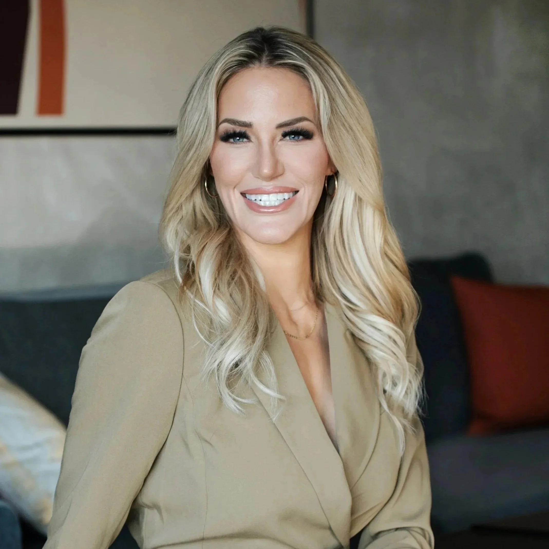Headshot of smiling female tutor with short blonde hair wearing a lanyard.