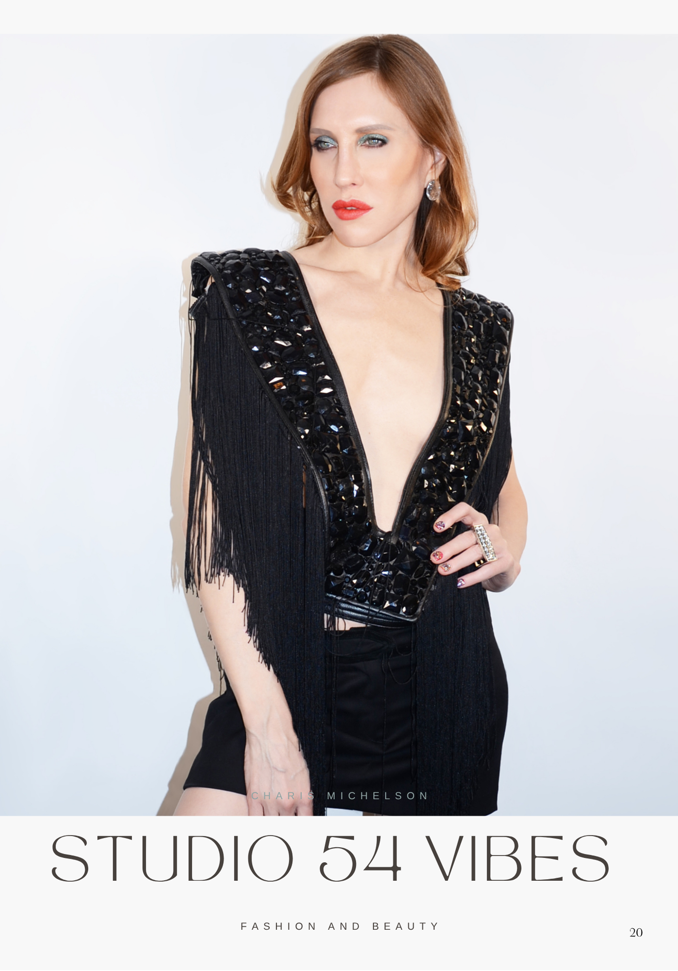 A woman with red hair wearing a black embellished top with fringes, looking to her left against a white background.