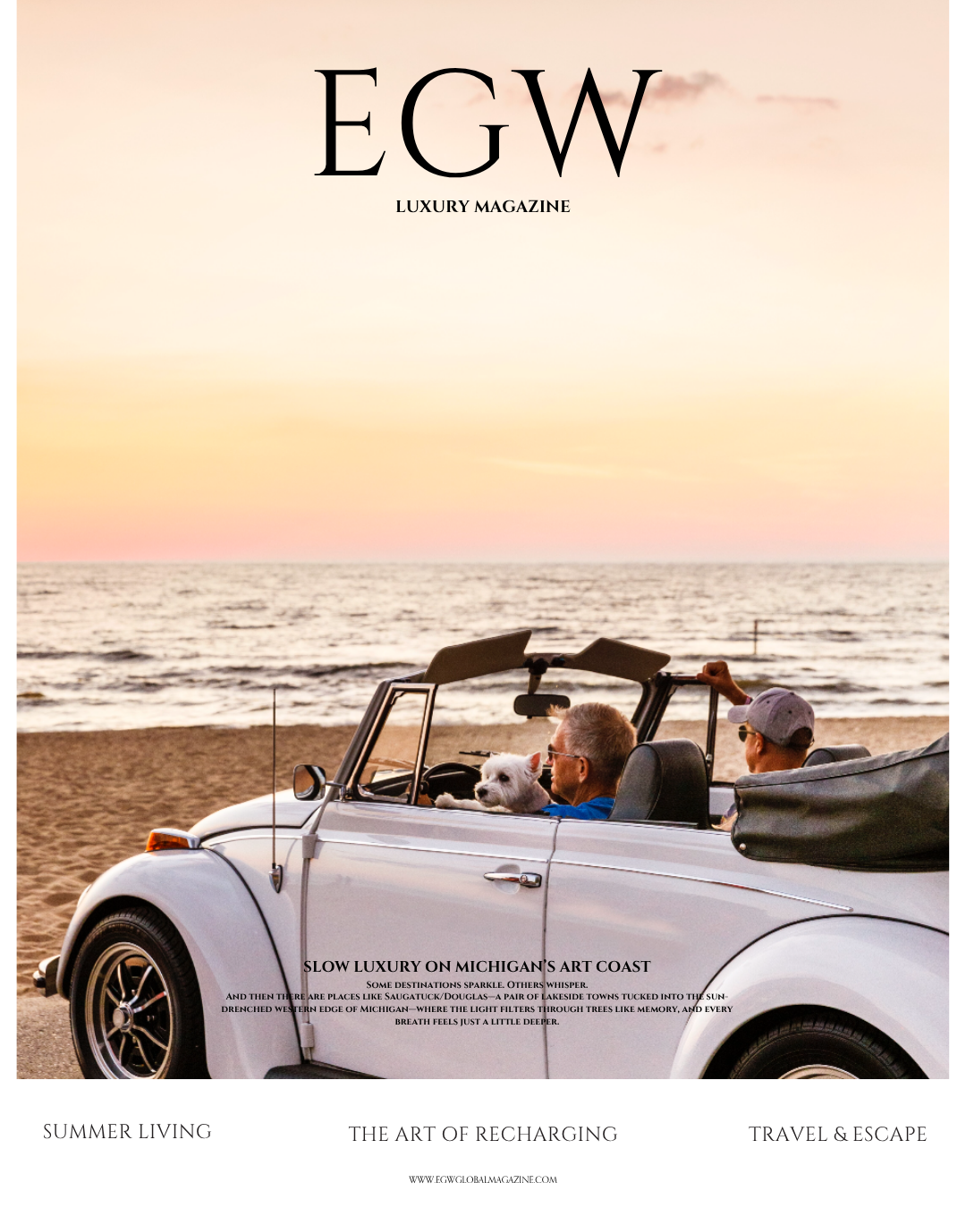 People and a dog in a convertible car on a beach at sunset with the ocean in the background, on the cover of EGW luxury magazine.