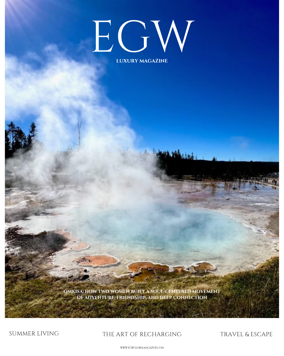 Cover of EGW luxury magazine featuring a geothermal hot spring with steaming water in a natural landscape, blue sky, and a forest in the background.
