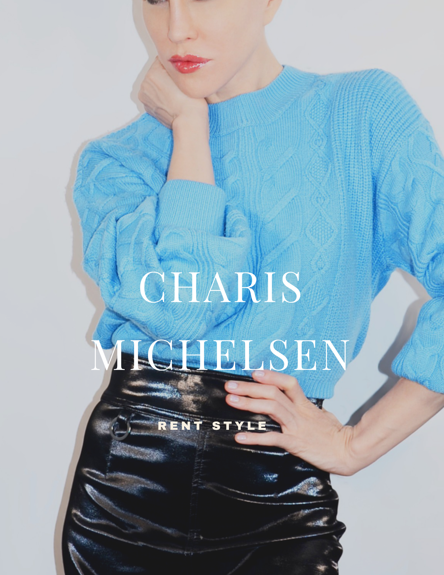 Close-up of a woman wearing a light blue sweater and shiny black leather pants, with her hand on her waist and her face partially visible.