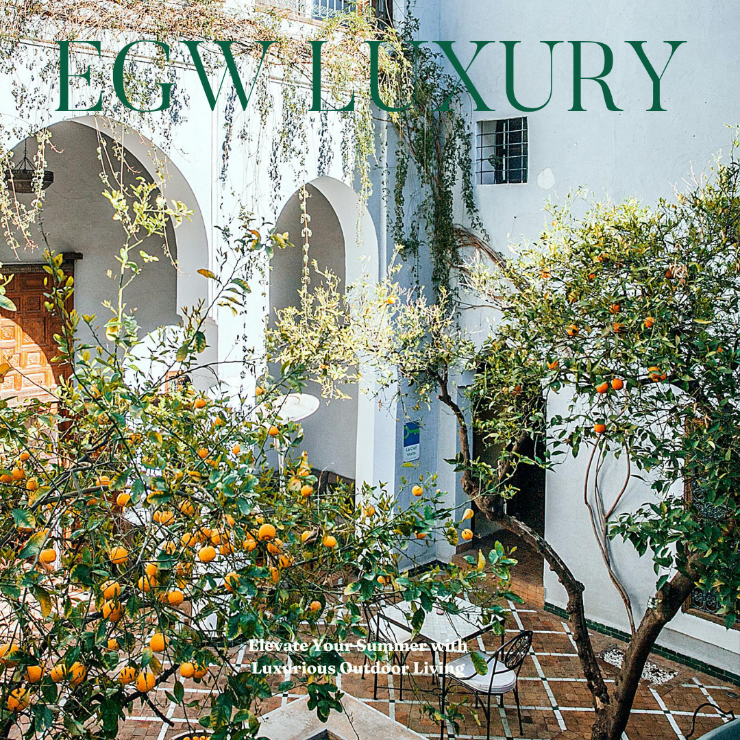 A courtyard with white walls, arched openings, orange trees, and outdoor furniture. The magazine cover has the title 'EGWLUXURY' and the subtitle 'Elevate Your Summer with Luxurious Outdoor Living'.