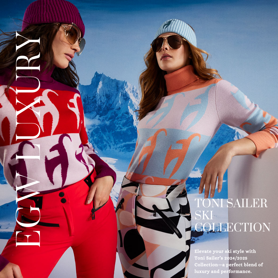 Two women wearing colorful ski sweaters, sunglasses, and ski pants standing in front of snowy mountains, advertising the Toni Sailer ski collection for 2024/25.