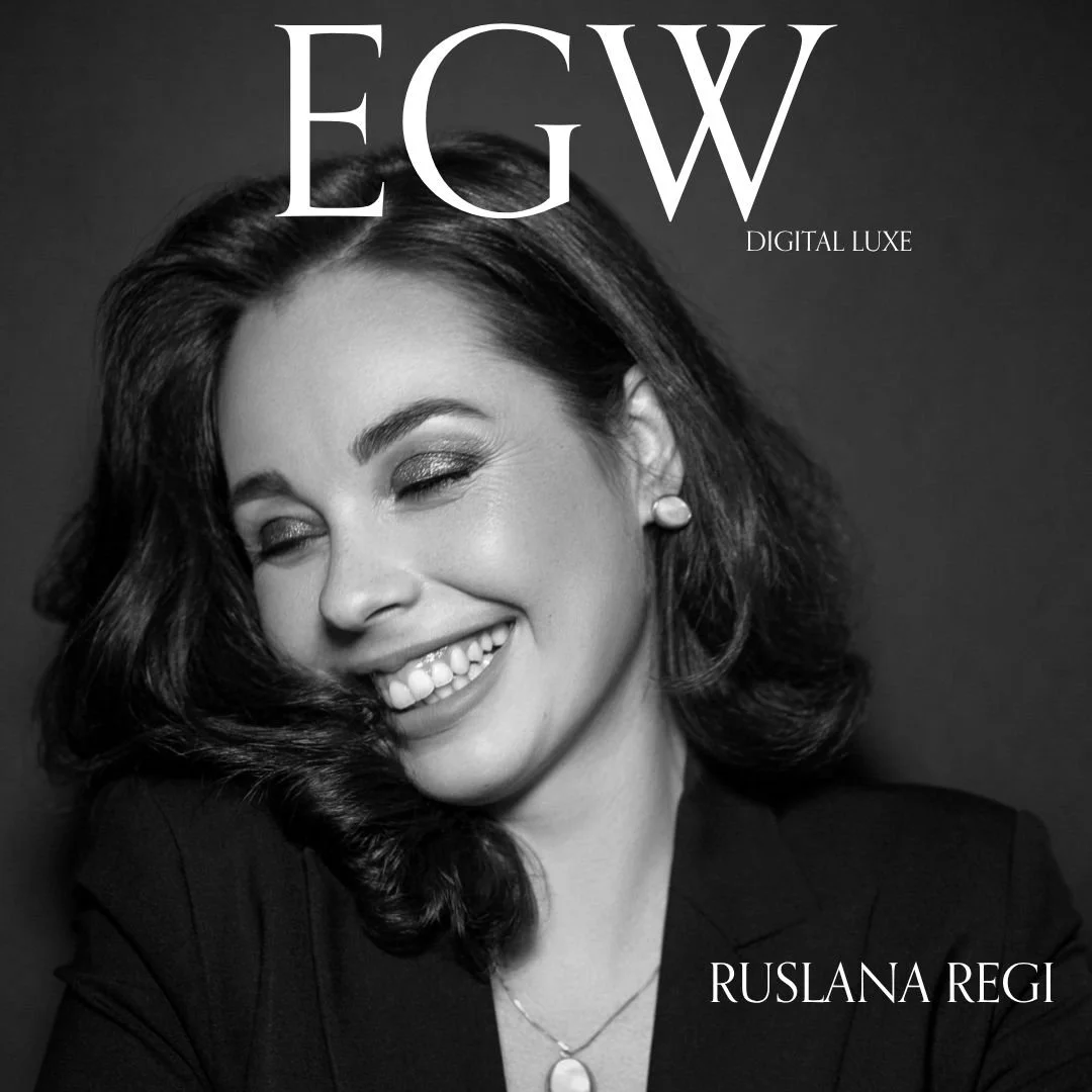 Black and white magazine cover featuring a smiling woman with wavy hair, wearing earrings and a necklace, with the headline "EGW DIGITAL LUXE" and the name "Ruslana Regi."