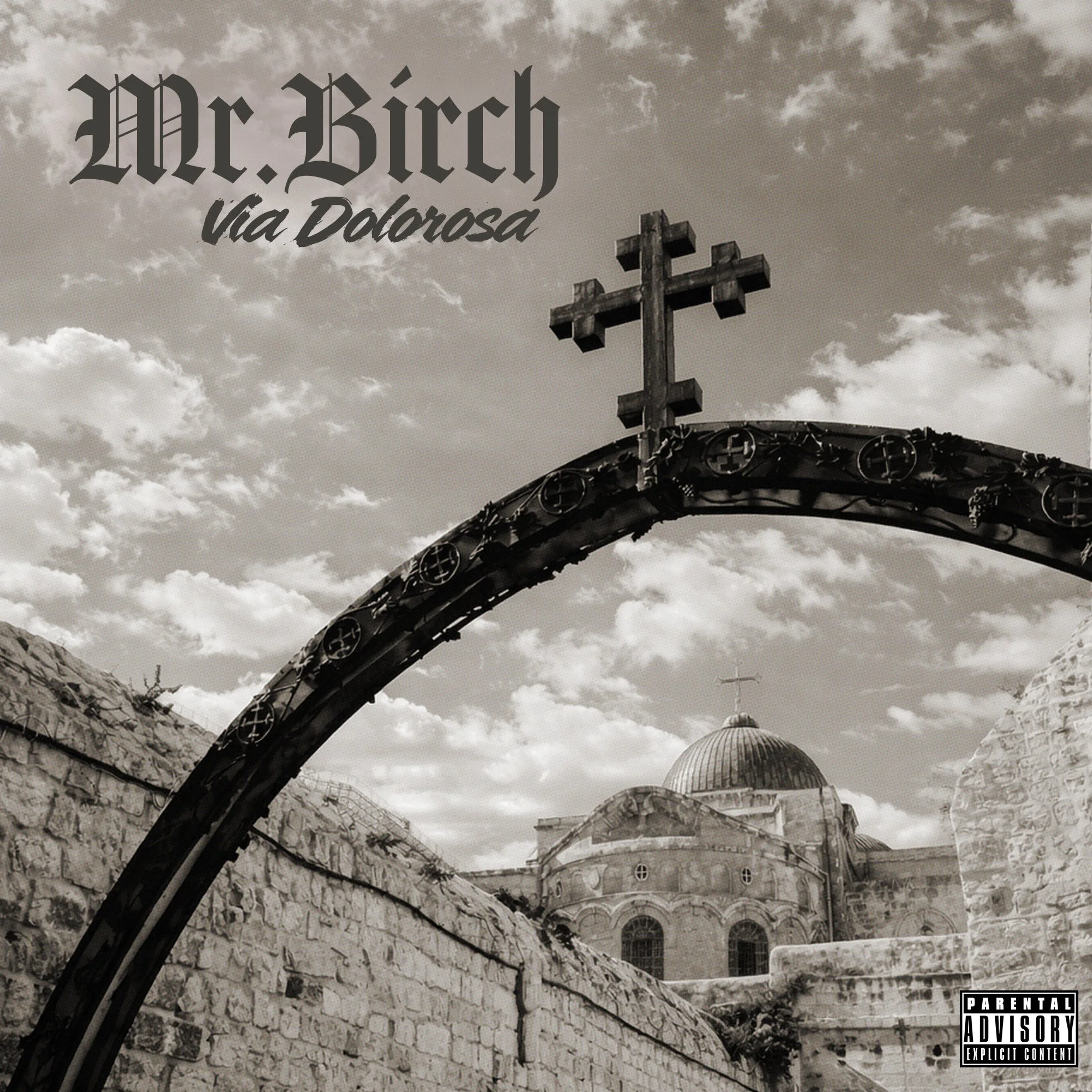 The album cover features a black and white photo of a religious building with a cross on top, a stone wall, and a cloudy sky in the background. Text on the image reads "Mr. Bitch via Dolorosa" in stylized font. There is a parental advisory sticker in the bottom right corner.