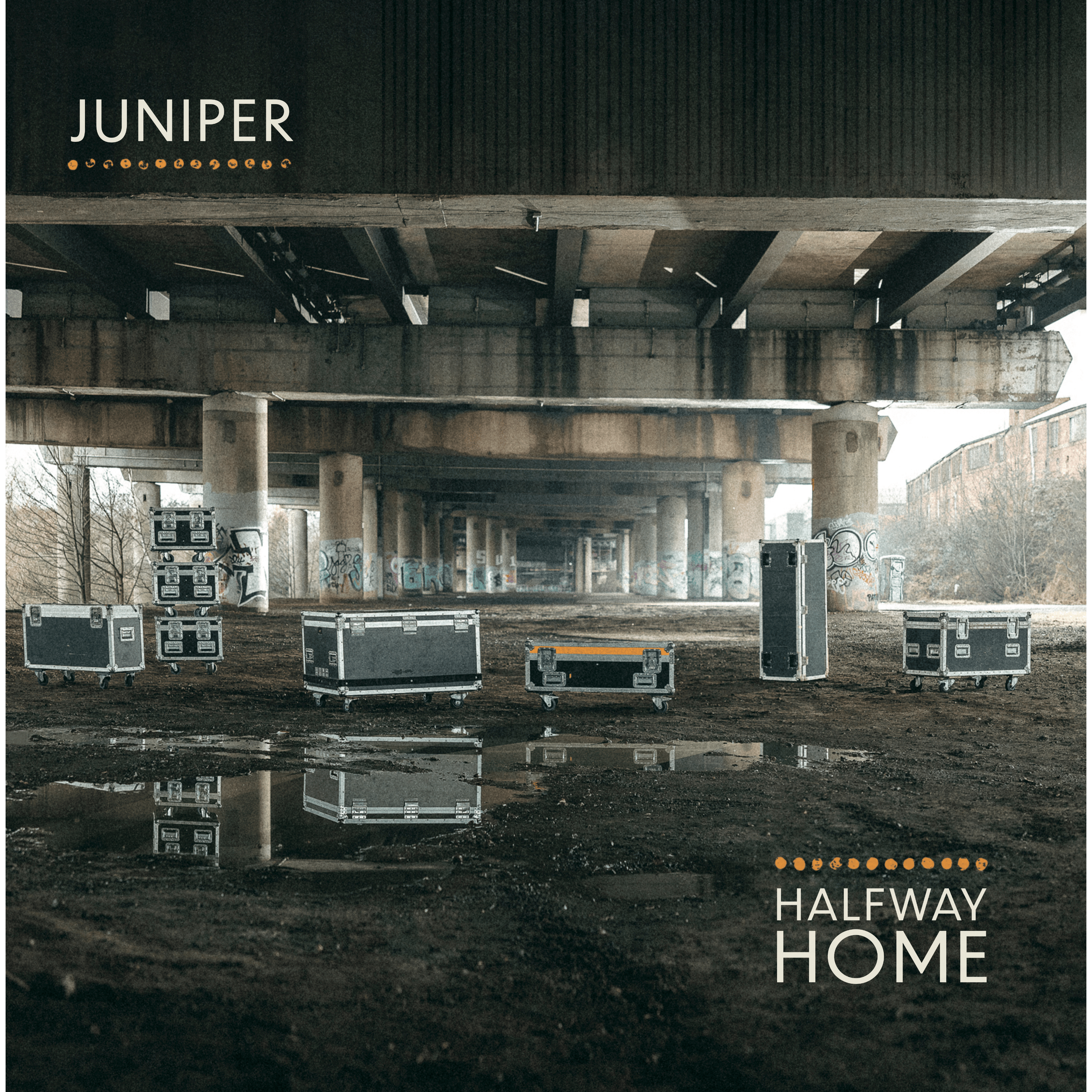 Album artwork for Juniper's second album, Halfway Home. Imagery of flightcases arranged under a graffiti-covered spagetti junction