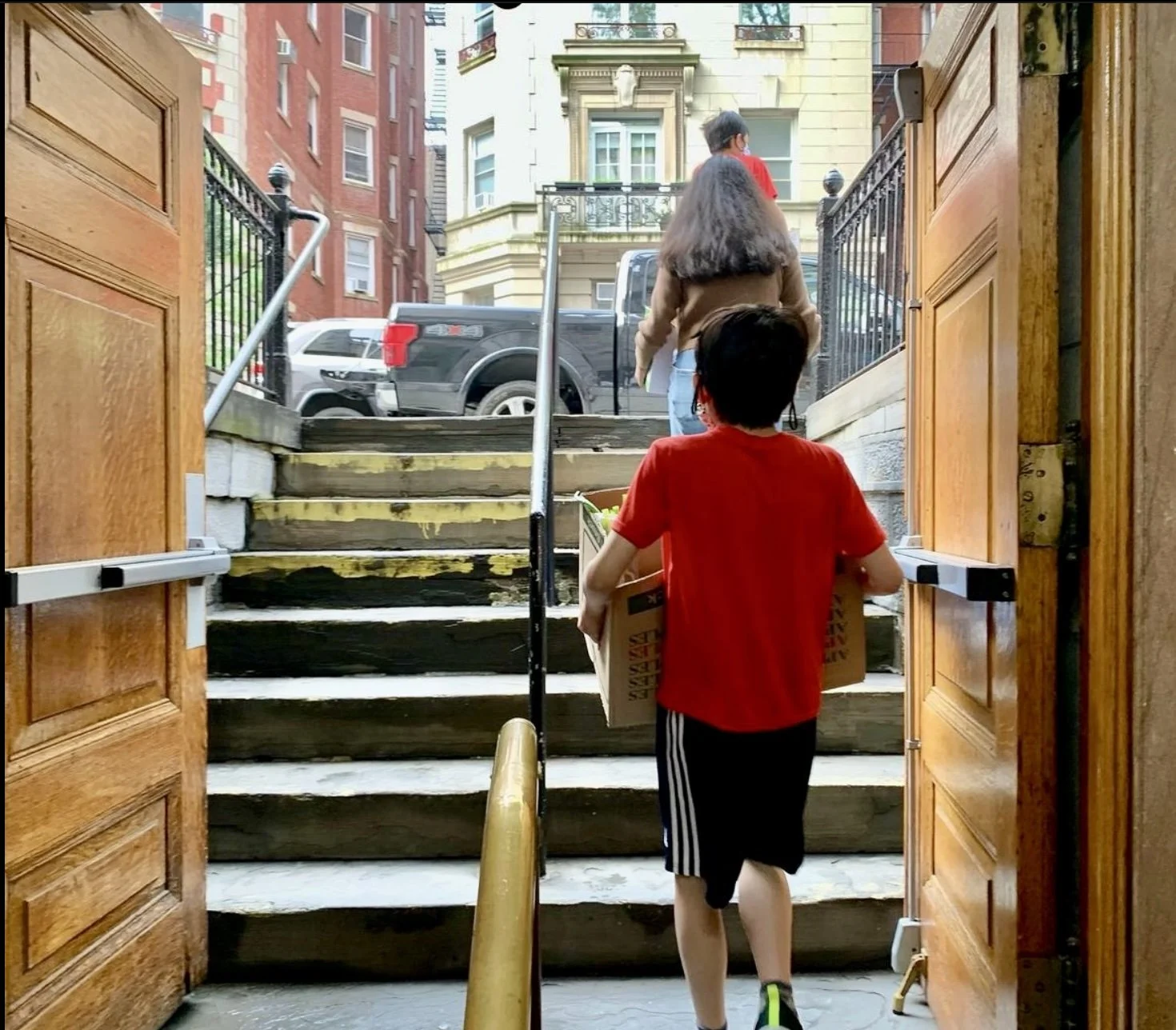 During the pandemic, the pantry began conducting deliveries to high risk clients. Volunteers carry personally packed boxes with food out of the church basement and either carry the bags on foot to nearby apartment buildings or drive with their famili
